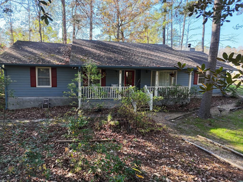 As the saying goes...... Location Location Location! Sitting in the middle of the wooded lot in town! So Cozy, 3 bedrooms and 2 baths, covered front porch looking out onto a wooded yard with a bridge over a creek.  Fireside den with bookshelf walls.  Near schools, near hospital. Call your favorite agent TODAY for a closer look!