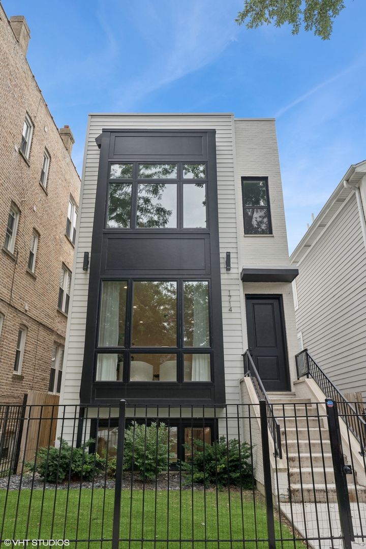 You are going to love this one year new construction Duplex-Down in Logan Square/West Bucktown! Experience luxury living in this beautifully designed duplex-down located in an exclusive two-unit boutique building. This home showcases top-tier craftsmanship, high end finishes, and a layout that perfectly balances style and functionality. The main level features an open concept floor plan with a formal front living/dining space, plus a separate spacious back family room anchored by a gas fireplace, wide plank white oak hardwood floors, and oversized windows that flood the space with natural light. The open chef's kitchen impresses with custom soft-close cabinetry, a secret hidden walk-in pantry and prep area, quartz countertops and backsplash, and a premium stainless steel appliance package. All four bedrooms are located on the lower level with newly installed vinyl flooring, offering quiet separation from the living space. The luxurious primary suite includes a spa inspired bath with a double vanity, freestanding soaking tub, separate walk-in shower, and elegant designer tile and lighting.  Private garage roof deck with a custom built out bar and privacy screen, ideal for creating an outdoor oasis. Custom window treatments and professionally organized closets throughout. 2 garage parking spaces included. Located just steps from the 606 Trail, public transportation, and all the dining, shopping, and culture that Bucktown, Logan Square and Wicker Park has to offer, this dream home is turn-key.