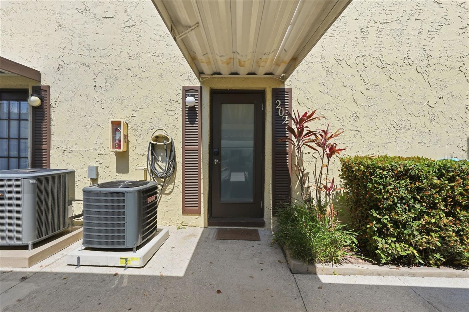 Beautifully updated home with numerous recent improvements! Most flooring has been replaced, and the entire interior was freshly painted in 2024, giving the home a clean and modern feel. Additional upgrades include plantation shutters (2024), updated kitchen and bathrooms (2024), and newly installed hurricane doors (2025), offering both style and peace of mind.This home feels easy and inviting from the moment you step inside. Spread across two levels, this townhouse-style condo offers 2 bedrooms and 1.5 bathrooms, with an open main living area perfect for relaxing, entertaining, and everyday living. The kitchen comes fully equipped with a range, refrigerator, dishwasher, microwave, disposal, washer, and dryer, making it move-in ready from day one.Upstairs, both bedrooms are privately tucked away, with the primary bedroom featuring a spacious walk-in closet and built-in storage for a highly functional layout. Multiple outdoor spaces, including a balcony, front, rear, and patio areas, give you room to enjoy fresh air or unwind after a long day.The community adds even more lifestyle value with a pool, clubhouse, sidewalks, and tennis courts, while a covered carport and assigned parking provide additional convenience. For buyers seeking a low-maintenance home that combines comfort, style, and resort-style amenities, this property delivers it all—functional without feeling basic, stylish without sacrificing practicality, and designed to make everyday life feel just a little bit better.