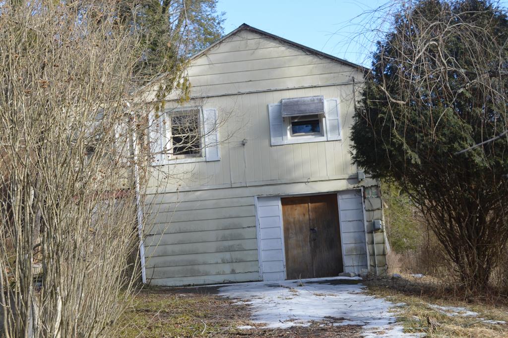 Investor and builder opportunity! This fixer-upper is a blank canvas, with the interior fully stripped and ready for your custom remodel or redesign. Bring your vision and create a home tailored to today's standards without the cost or delay of demolition.  The property is currently connected to a septic system; however, two public sewer taps and two public water hookups are already present on the property, offering valuable flexibility for future development or expansion. Situated on a large lot with potential for two dwellings, this parcel provides an excellent opportunity for redevelopment, multi-unit planning, or maximizing long-term value (buyer to verify use and zoning). Please note that property restrictions do not allow manufactured homes. Ideal for investors, contractors, or buyers looking to build equity through renovation or development. Convenient utility access, generous lot size, and strong potential make this a standout opportunity for those ready to bring new life to this property. Sold as-is. Buyer to verify all utilities, permits, and development potential.