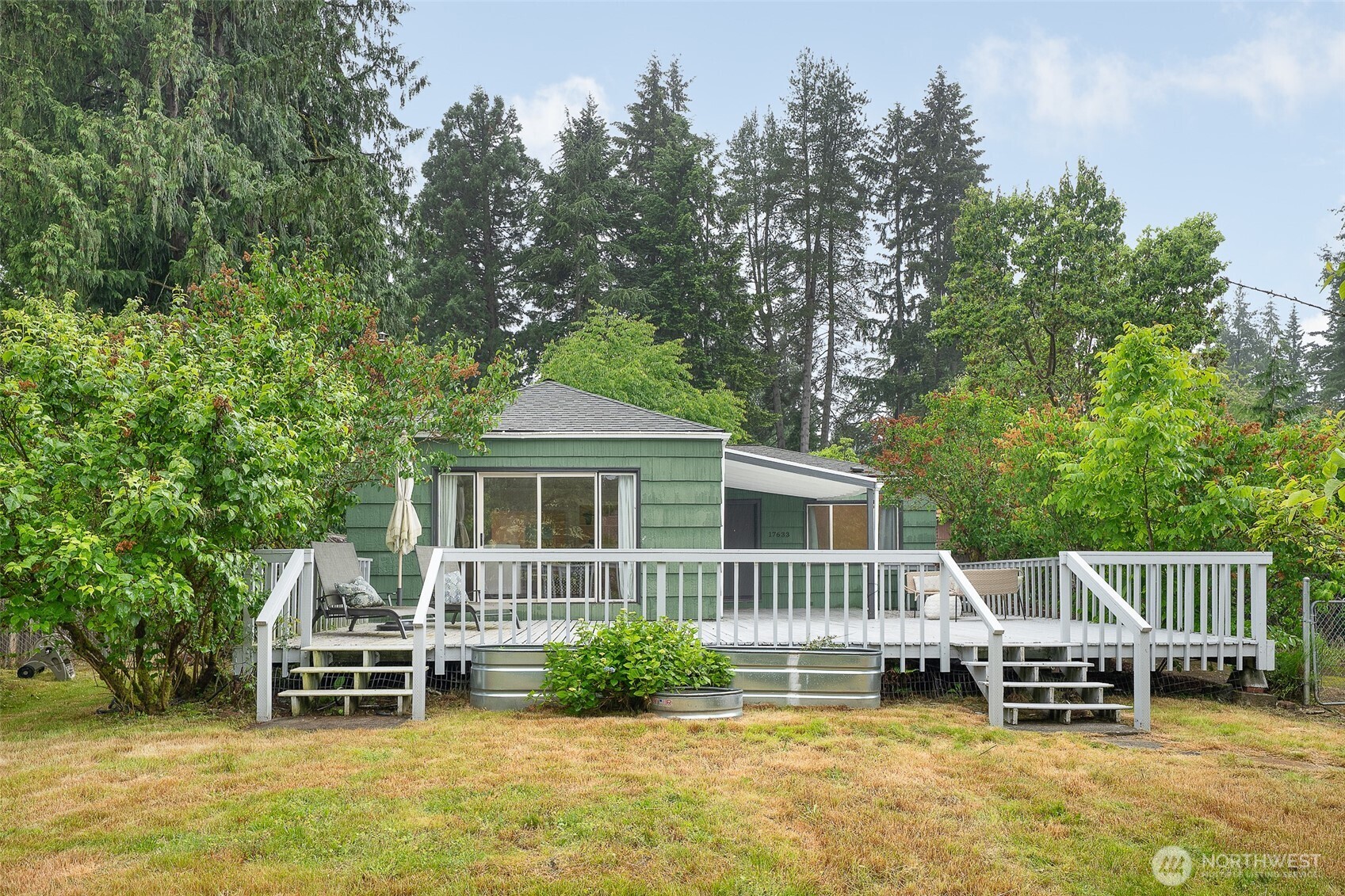 Bright, move-in-ready rambler positioned on a flat 9,147 sq ft lot in one of Shoreline’s fastest-growing areas, just moments from the new 185th Light Rail Station for an easy commute into Seattle. Beyond the immediate convenience and livability, this property offers significant future potential with upcoming multifamily zoning changes expected to create substantial redevelopment value over time.    Extensive structural and system improvements have already been completed, including replacement of the original knob-and-tube wiring, reinforced foundation work with new helical piles, an upgraded retaining wall, and a refreshed deck designed for entertaining and everyday enjoyment. Major appliance updates—including the refrigerator, dishwasher, washer, and dryer—add to the home’s turnkey appeal.    Inside, natural light fills the comfortable single-level layout, while the fireplace creates a warm and welcoming central gathering space. Sliding glass doors connect the interior to an oversized back deck and expansive yard, offering plenty of room for outdoor dining, gardening, play, or hosting guests. The grounds are a true gardener’s dream, featuring mature roses, fruit trees, and abundant space to expand or cultivate your own outdoor vision.    With close proximity to parks, restaurants, shopping, and quick I-5 access, this property presents a rare opportunity to enjoy a well-cared-for home today while securing a highly desirable investment for the future.