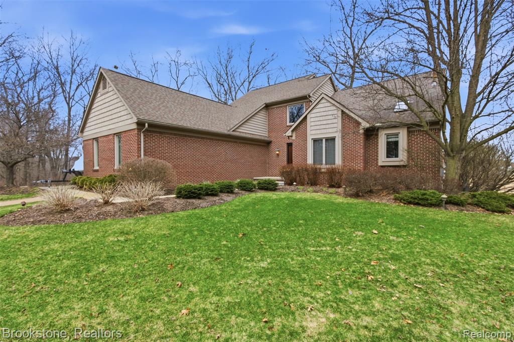 Welcome to a one-of-a-kind custom home on All Sports Big Lake nestled on nearly 12 acres in a peaceful corner of Springfield Township. Set back on a dedicated paved drive this meticulously maintained residence offers a blend of privacy, tranquility, and lakefront living. Offering panoramic views of Big Lake from multiple rooms and the sprawling deck. Stroll down the shared boardwalk to your exclusive lake frontage and additional yard space perfect for firepit, lawn furniture and front row seats for the annual Big Lake fireworks. Inside the first-floor master suite boasts a spa-inspired bathroom featuring jetted tub and glass enclosed shower. The Kitchen offers counterspace and storage galore.  Adjacent large dining room with views overlooking the lake can comfortably accommodate those large gatherings. Main level also has a versatile office/flex-room/den, laundry room and half bath. Upstairs, you’ll find two generously sized bedrooms and a full bath, offering ample space for visiting guests. Prepare to be amazed by the jaw-dropping finished walkout lower level. Cozy up by the gas fireplace, entertain at the show-stopping granite bar that features a sink, mini fridge, dishwasher, and electric cooktop. Get a workout in your own dedicated sprawling fitness room that could be used for an additional guest bedroom with adjacent lower level full bathroom with euro glass and custom vanity .  Unwind in the custom built-in McCoy dry sauna. There’s even room for a pool table and more making this space a true entertainer’s paradise. The property also features a spacious 3-car insulated and heated garage (w/ newly installed insulated garage doors), covered boat hoist, floating dock, central vacuum system, bonus attic storage, newer Anderson windows and sliding doors throughout. Also, surround sound speakers in living room and lower level. For ease of boardwalk access to the lake a golf cart can be used to entrance of dock.