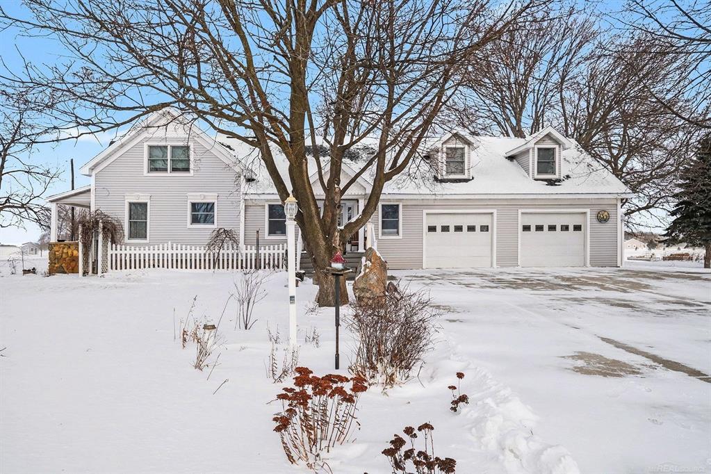 Extensively renovated in 2010 and thoughtfully improved over time, this exceptional property blends authentic character with modern comfort in a way that feels both intentional and livable. Multiple updates, including a well-integrated addition, complement the original structure, creating a home that lives far more contemporary than its age suggests. With 4,420 square feet of finished living space, the home is in excellent condition, meticulously maintained, and truly move-in ready.  Set on 5 acres, the property is ideally suited for a hobby farm, homesteading, or those simply seeking space and privacy. A fully fenced 3-acre pasture offers an ideal setup for horses or livestock, while three separate barns provide flexibility for animals, equipment, storage, or workshop use. The property is serviced by two wells, including a dedicated livestock well, allowing for efficient operation of the pasture and outbuildings without impacting household use. The layout of the land supports usability and function without sacrificing the peaceful, open feel of the setting.  Inside, the home offers generous and flexible living spaces throughout, including a main-level bedroom and full bathroom, providing convenience and accessibility for guests or everyday living. The expansive primary bedroom features a large walk-in closet and additional space well suited for a sitting area, office, or private retreat. Over the garage, a massive upper-level bedroom includes a combined living area and ensuite bath, along with its own private entrance, making it ideal for guests, extended living, or multi-generational use. A small bonus room adds further versatility for hobbies, storage, or a quiet workspace.  The home is equipped with zoned geothermal heating, offering energy-efficient comfort, customized temperature control, and long-term operating savings. The finished garage incorporates barn wood sourced directly from the property, a subtle and meaningful nod to the land's history. Throughout the home, updates have been completed with care,