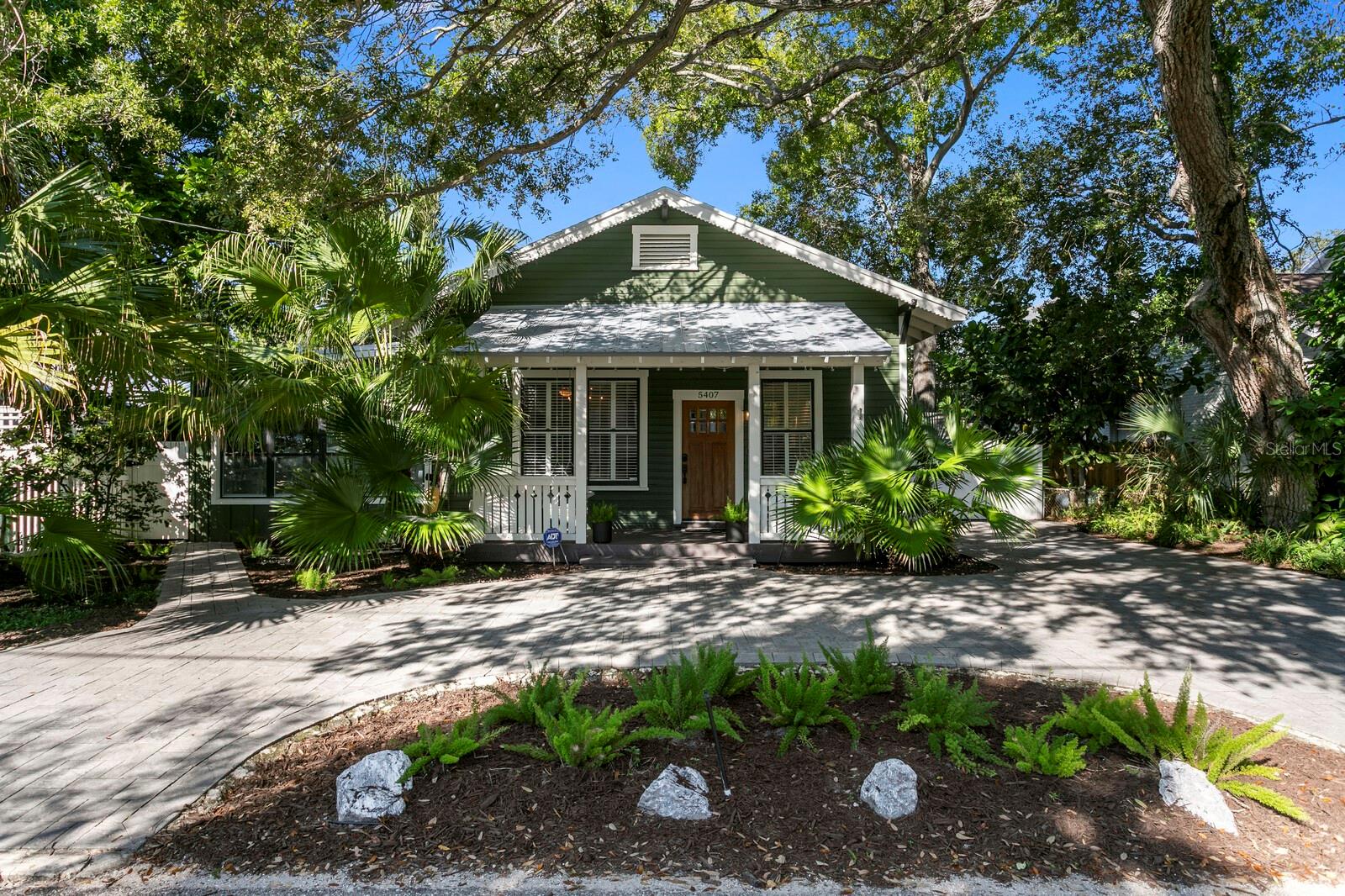 Welcome to 5407 Russell Street in South Tampa. Originally built as a church in 1924 with soaring 12' ceilings, the building was converted to a single family home in 1950. Since then, continued improvements have turned it into the gem that it is today. You are welcomed into the home from your charming front porch complete with two person swing. Once inside you'll enjoy the open floor plan which incorporates the kitchen, living and dining rooms, and opens to the recently added bonus room.  The kitchen has white cabinets, granite countertops and stainless appliances, with ample storage. The bonus room is very large and surrounded with windows to create a nice bright space that overlooks the back yard. Three good sized bedrooms were all thoughtfully designed with built ins and storage for multi-purpose uses. The master bedroom has a large walk in closet and recently upgraded en-suite bath with double vanity and designer-tiled shower. The laundry is conveniently located near the bedrooms and has plenty of extra storage space.  This property offers a low maintenance yard with turf in the back yard, and the playset is an added bonus for the little ones! Zoned for top public schools Ballast Point Elementary, several IB and magnet middle schools nearby, and the highly regarded Robinson IB High School. All of this in South Tampa close to the iconic Bayshore Blvd., and a short drive to Hyde Park Village, downtown Tampa and the beaches of St Pete. Call today for your private tour.