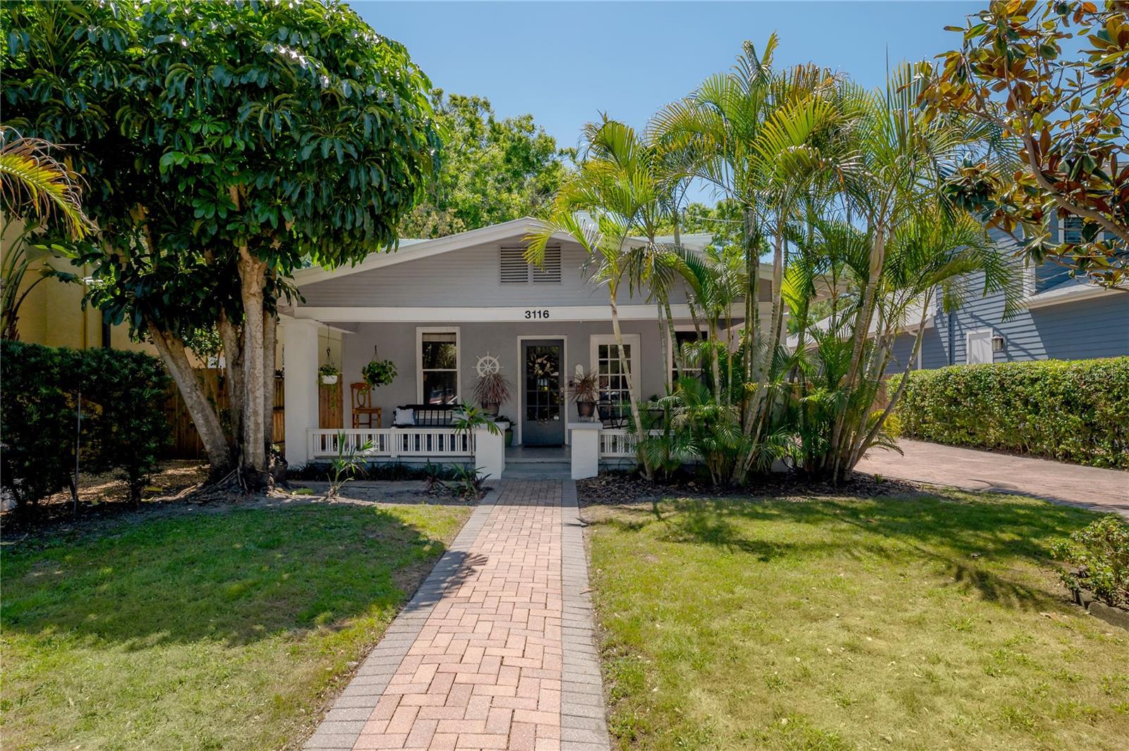 Rare 1929 Airplane Bungalow in the Bayshore Beautiful section located within the coveted Plant High School District, offering increased lot value. In addition, the lot is oversized for this neighborhood, not in a flood zone and has never flooded as per owner’s knowledge since 2009. Your private oasis awaits in this timeless gem, situated just one block from Bayshore Boulevard, the longest continuous waterfront sidewalk in the world. Built in 1929, this rare home combines historic charm with a 2025 makeover for selling purposes, creating the perfect blend of character and comfort, further enhanced by the outdoor bliss of an oversized backyard. *** OUTDOOR FEATURES *** The exterior features a classic covered front porch with beadboard ceiling and concrete pillars, and a large, well-maintained, gated backyard with wood fencing, making it ideal for relaxing or entertaining. The peaceful patio, lush raised gardens, blooming trees, and hot tub add to the outdoor enjoyment, while the versatile backyard also offers potential for a 1-car enclosed parking pad in addition to the 4-car driveway, as well as a large workshop and covered outdoor workstation. *** INTERIOR FEATURES *** Inside, open living areas and thoughtful renovations preserve the bungalow’s signature appeal, with the oversized upstairs “cockpit” bedroom featuring 10 windows and an ensuite bathroom that provides abundant natural light and a serene retreat. Both bedrooms, including a convenient first-floor master suite, are complete with ensuite bathrooms. The updated kitchen embraces a country bungalow feel with stainless steel appliances, a farm sink, French door refrigerator, quartz backsplash, and a breakfast bar, while the warmth of a brick fireplace and Craftsman-style window and door casings accentuate the charm throughout. The renovated master bathroom showcases bamboo floors, a tub with custom subway tile walls, frameless glass door, and recessed lighting. *** ADDITIONAL FEATURES *** 2025 interior paint, new closets, new light fixtures and ceiling fans, a newly permitted upstairs mini-split AC, and termite fumigation, along with 2022 exterior paint, a 2022 kitchen renovation with new common area flooring, a 2019 first-floor bathroom renovation with new flooring, most newer windows, and a durable 2004 steel metal roof with a 40–50 year life expectancy (as per google search). The home also includes first-floor block construction, subterranean termite protection stations, 2017 A/C and 200-amp panel upgrade. Located within the highly sought-after Plant High School District, this residence is just steps from South Tampa’s finest restaurants, bars, grocery stores, and shopping, offering a lifestyle that balances tranquility with convenience and making this property a rare opportunity to own a piece of Tampa history.