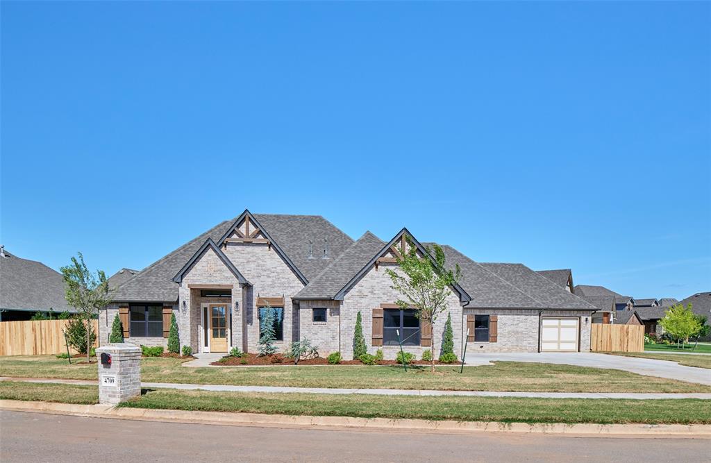 This home features four bedrooms and three and a half bathrooms, combining contemporary design elements with natural, rustic accents. The house boasts a charming exterior with modern and rustic elements. The facade combines clean lines, natural materials, stone, and wood, creating a warm and inviting atmosphere. Large windows and a covered porch provide an excellent connection to the outdoors. Upon entering, you step into an open-concept living area that seamlessly integrates the kitchen, dining room, and living room. The space is characterized by high ceilings, a stone fireplace, and large windows, allowing ample natural light to flood the area. The flooring is light creating a modern rustic feel. The kitchen features sleek, modern appliances and fixtures. A large center island provides additional workspace and doubles as a breakfast bar. Nestled off of the kitchen are 3 secondary bedrooms and two baths that are anchored by a second living area. This is a great space to watch a movie, do homework or play games. The primary retreat features rustic beams with a lot of natural light. You will love the seclusion this retreat offers as well as the spa-like bath. The center stage of the primary bath is the freestanding tub. Relaxation is easy in this space. The Primary Closet has a center chest of drawers with seasonal rods. If you love outdoor living this home has it. There is plenty of space for a seating and dining area around the outdoor fireplace. A study, 1/2 bath, & formal dining complete this home. Owner is Licensee. O/A