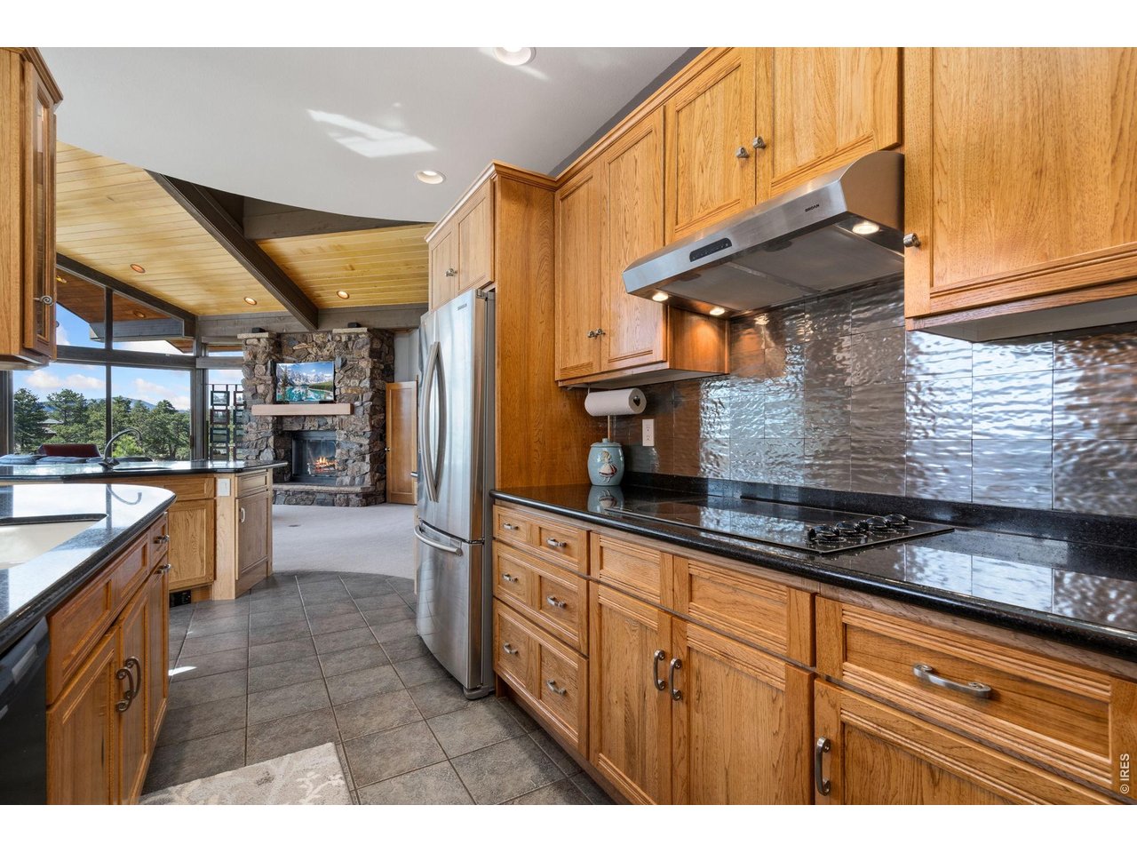 Welcome to 10 Mariposa Court in the Gated Fox Acres Community of Red Feather Lakes. An extraordinary mountain retreat where architectural design and natural beauty come together seamlessly. Designed by acclaimed BVZ Architects of Boulder, this home reflects decades of their expertise in crafting distinctive residences. Set on a 1/4 acre lot, the property captures breathtaking views of the surrounding mountains, scenic water views, and the golf course while providing a sense of privacy and seclusion. As part of Fox Acres Community, you'll also enjoy access to exclusive community amenities that elevate the lifestyle. A grand covered front entry creates a warm welcome, leading inside to a view that immediately frames the incredible scenery beyond. The home opens into an expansive great room, where floor-to-ceiling windows showcase the panoramic views, anchored by a beautiful stone fireplace. The kitchen flows into the great room, featuring a central island and dining area surrounded by windows perfect for entertaining with a view. Just off the great room, a private office offers an inspiring space to work or unwind. The main-level primary suite sits in its own wing, complete with vaulted ceilings with floor-to-ceiling windows capturing stunning Leticia Lake views. The spa-like bath includes heated tile floors, a walk-in shower, jetted tub, and a spacious walk-in closet. Also on the main level are a laundry room with built-in cabinetry and a mudroom. Upstairs, a second primary suite includes a full bath and walk-in closet, along with a den and versatile Art/Hobby room with expansive windows and incredible views. Outdoor living shines with a slate patio designed for dining and entertaining while taking in the panoramic surroundings. This custom home offers a rare opportunity to own a truly unique mountain property combining timeless architecture, unmatched views, and the exclusive lifestyle of Fox Acres Golf Community, in a setting for your own private mountain escape!