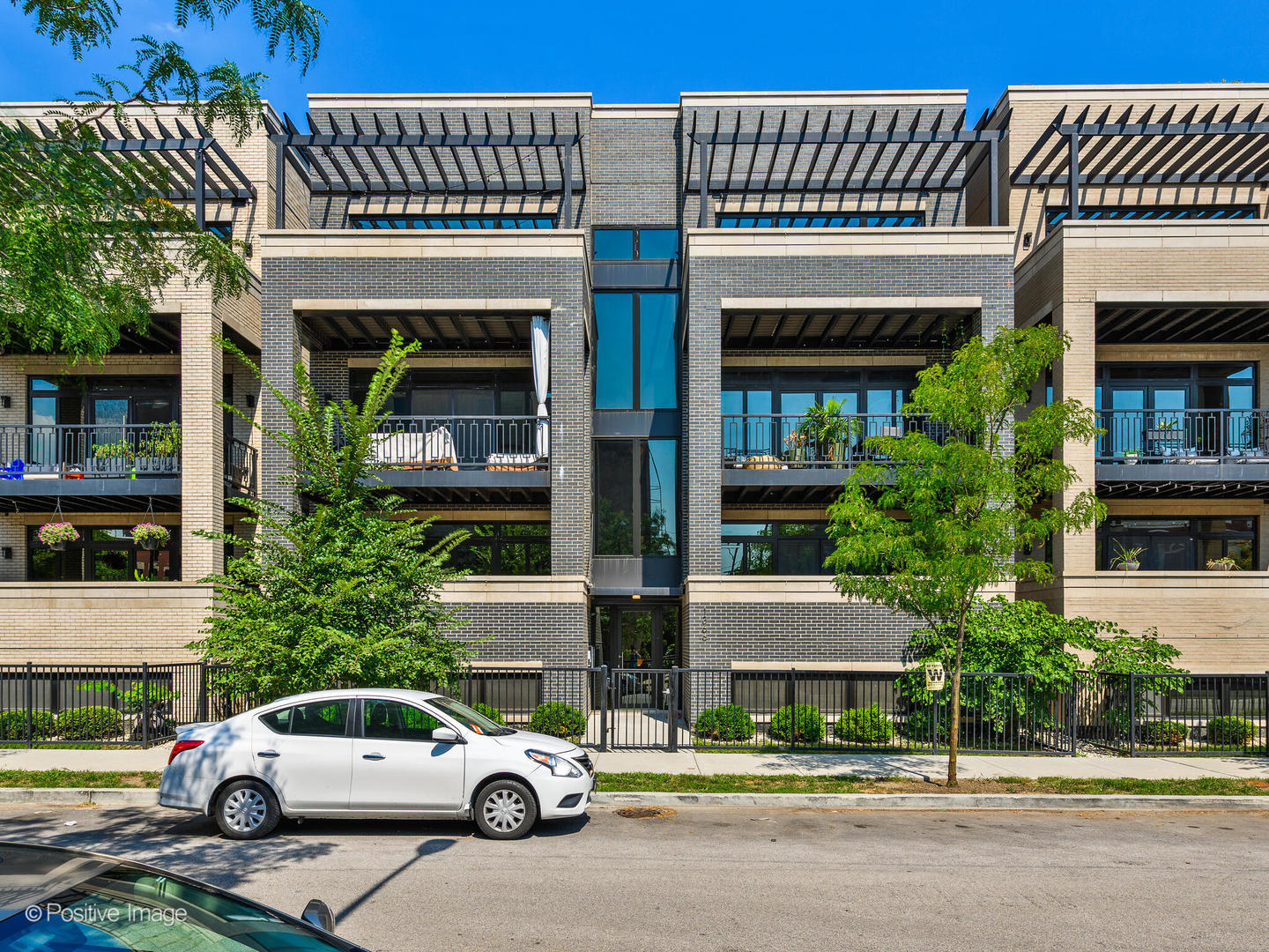 Introducing an extra-wide, 3-bedroom, 2.1 bathroom duplex built and designed with distinction by award-winning Noah Properties in collaboration with Axios Architects. This modern  masterpiece combines architectural sophistication with high-end functionality, offering the space, finishes, and lifestyle of a single-family home at a fraction of the price. This residence  includes one-car garage parking with a dedicated level 2 EV charging outlet (14-50) and a spacious garage roof deck enhanced with a custom pergola-the perfect setting for outdoor living, dining, or  entertaining. Two additional covered balconies (front and rear) further extend the home's private outdoor space. The open-concept main level is filled with natural light and showcases a  sleek, contemporary design. The chef's kitchen features custom-designed cabinetry, waterfall quartz countertops, designer fixtures, and a premium Bosch appliance suite. The main level also includes the formal living and dining area with a fireplace, powder room, family room with a second fireplace and hardwood floors throughout. On the lower level, enjoy radiant heated floors throughout. The primary suite is a retreat of its own with two walk-in closets and a spa-inspired bath that includes a double vanity, freestanding soaking tub, steam shower, heated floors, and designer tile selections. Additional bedrooms are generously sized with custom closet build outs and share access to a thoughtfully designed bathroom with high-end finishes. The radiant-heated lower level offers a second fireplace, media/family room,  and versatile space for work or play. Every detail reflects elevated craftsmanship, from wide-plank flooring, sophisticated lighting, high-end European casement windows, and custom millwork throughout. Ideally located in vibrant Noble Square/East Village, this home offers easy access to the expressway, Blue Line, restaurants, cafes, and nightlife. Unprecedented in style, design, and scale-this home  delivers the feel of a single-family residence with modern convenience and low-maintenance living.