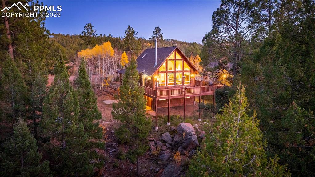 Set against the striking backdrop of Turkey Rocks, this one-of-a-kind 2-bedroom, 2-bath A-frame in Turkey Rock Ranch Estates offers a blend of seclusion, style, and outdoor access. Positioned to capture its setting, the home showcases soaring panoramic cathedral windows that frame the rock formations while filling the interior with natural light. Enjoy peaceful surroundings, along with reliable, year-round access via county-maintained roads. The driveway is easily navigable with ample parking, including RV space.Inside, the home features a well-designed layout with a cozy mountain feel. A wood stove anchors the main living area, creating a warm and inviting environment ideal for relaxing after a day of adventure. The open kitchen and dining area flow into the living room, making the space functional for everyday living and entertaining. A main-level bedroom adds convenience, while the upper level loft provides additional sleeping space for guests or family.Step outside to the wraparound deck and take in unobstructed views of the surrounding forest and dramatic rock formations—perfect for morning coffee or evening gatherings. The oversized garage adds utility and offers potential for future expansion into additional living space or a workshop.Outdoor recreation is at your doorstep. Optional membership to the Turkey Rock Rec Association grants access to private trails and 11 stocked fishing lakes along Turkey Creek. Nearby destinations include the South Platte River and Cheesman Lake for fishing, the Turkey Rocks climbing area, and miles of OHV trails.Whether you’re searching for a full-time mountain home, a private getaway, or an income-producing investment, this property delivers versatility. Currently professionally managed as a vacation rental, it provides an opportunity to enjoy the Colorado lifestyle while generating revenue.