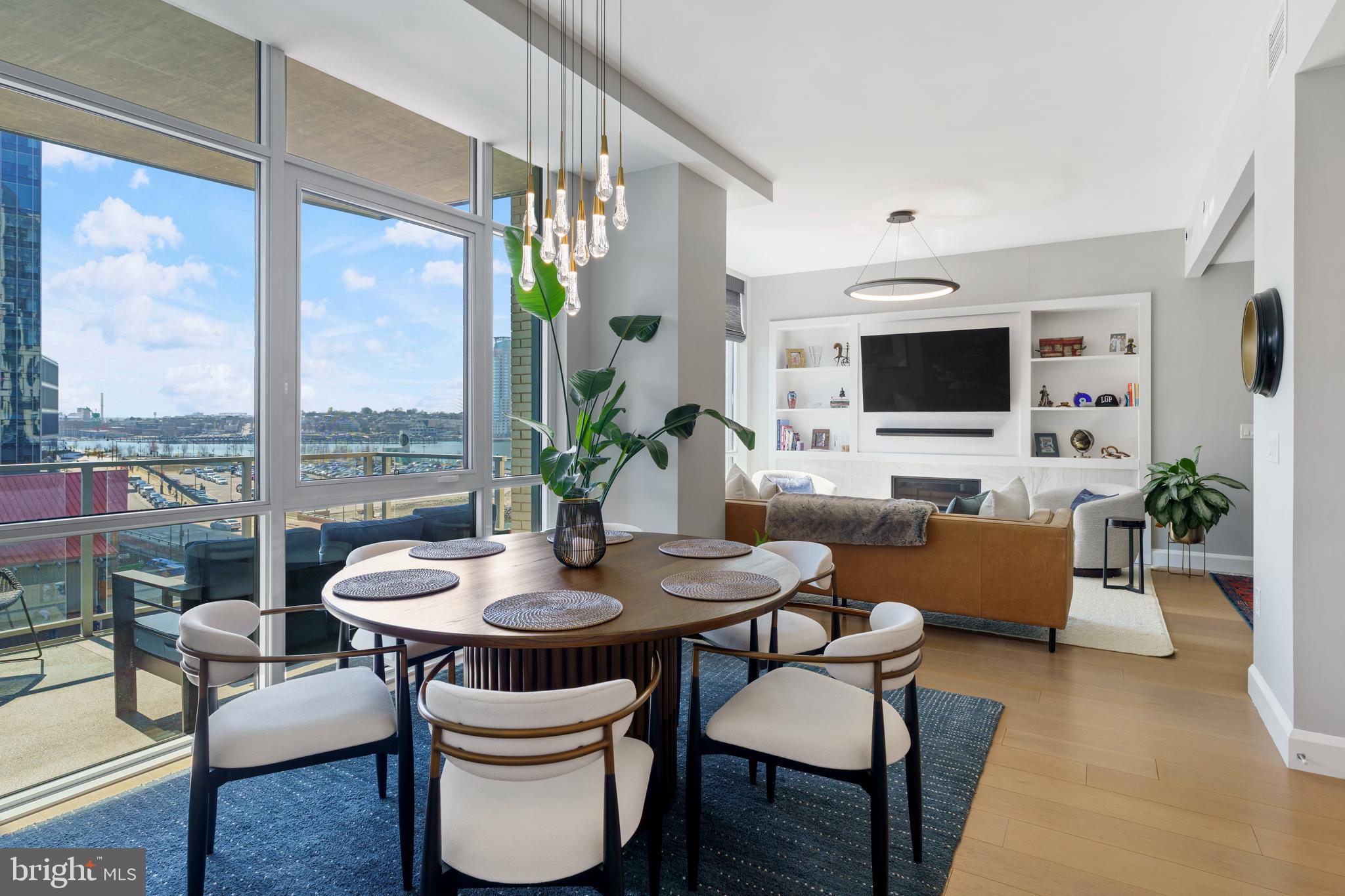 Welcome to waterfront, elevated city living at The Liberty Harbor East, one of the most sought-after boutique residences in Harbor East, where modern design meets vibrant waterfront energy.This extraordinary fifth-floor residence, built in 2019, offers 1,163 square feet of refined living space with one bedroom, one full bath PLUS DEN! Recently enhanced with thoughtful, high-end upgrades, the home now features fresh designer paint, new modern lighting with Lutron smart lighting system, and custom built-ins that elevate both style and functionality. The layout has been reimagined with the removal of the wall between the den and living area, creating an even more open and expansive living space, perfect for today’s lifestyle. From the moment you enter, you’re greeted by soaring 10-foot ceilings and dramatic floor-to-ceiling windows that flood the home with natural light while showcasing breathtaking southwest views of downtown Baltimore. New custom blinds, fully integrated with Alexa for smart home convenience, add both luxury and ease of living.The living and dining areas flow seamlessly into a chef’s kitchen featuring sleek Italkraft cabinetry, premium Thermador appliances, and a striking Calacatta marble waterfall island, ideal for entertaining. Tucked privately beyond the foyer, the spacious primary suite has been elevated with a stunning custom wood-paneled accent wall and offers access to a private balcony overlooking the iconic Inner Harbor. The spa-inspired bath is a true retreat, featuring Carrara marble, Kallista and Kohler fixtures, an expansive walk-in shower, and a custom dual vanity, while the oversized walk-in closet provides abundant storage.  Additional upgrades include a whole-house water filtration system and a new hot water heater, ensuring comfort and peace of mind. Residents of The Liberty enjoy a full suite of resort-style amenities, including a rooftop infinity pool with cabanas, a state-of-the-art fitness center and yoga studio, pet park with agility equipment, and beautifully designed social spaces such as a clubroom with indoor/outdoor bar, private dining rooms, and a concierge lounge. Additional conveniences include a secure package room, ButterflyMX smart intercom system, conference rooms, EV charging stations, and garage parking availability. Adding to the unmatched lifestyle, The Liberty offers direct access to a flagship Whole Foods Market, making everyday living effortless. Just steps away, Harbor East is home to some of Baltimore’s finest dining, boutique shopping, and scenic waterfront promenades, placing the very best of the city right outside your door. This is more than a home, it’s a lifestyle defined by luxury, convenience, and sophistication in one of Baltimore’s premier waterfront communities.
