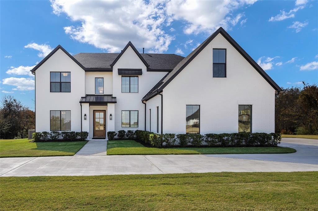 Experience the perfect blend of European elegance and American comfort in this uniquely designed home, set on a rare, tree-lined lot. Crafted by a European designer with meticulous attention to detail, the interiors radiate harmony through light, earth-toned palettes, soft textures, and timeless finishes. French oak hardwood floors, Calacatta quartz countertops, and marble tiles complement premium lighting from Arhaus, West Elm, and Pottery Barn, while champagne bronze Delta fixtures add a refined touch throughout. The open-concept family floor plan is designed for modern living. Sun-drenched living spaces feature oversized windows framing serene views, a gas RealFlame fireplace, custom white oak shelving, and a statement chandelier, blending elegance with a warm, inviting ambiance. The oversized kitchen is a chef’s dream: an oversized island with seating for eight, Calacatta Mia quartz countertops and backsplash, Bianco farmhouse sink, top-of-the-line KitchenAid appliances, and custom LED-lit cabinetry create a space that’s as functional as it is beautiful. The primary suite is a private retreat with expansive views, walk-in closet, and a spa-inspired bath with a freestanding Roman tub, Bianco Carrara marble shower, double vanity, and matching high-end fixtures. Generously sized secondary bedrooms and baths, a thoughtfully designed laundry and mudroom, and custom storage elevate everyday living. Every detail of this home—from spray foam insulation and tankless water heating to electric-car-charging preparation—reflects sophisticated, thoughtful living. Outdoors, the home is prepared for a pool and outdoor kitchen, with lighting, landscaping, and a circular driveway enhancing its curb appeal. Located in an active, vibrant community with events like classic car exhibitions, dance parties, and festive celebrations, this home offers a lifestyle that seamlessly combines luxury, comfort, and connection.