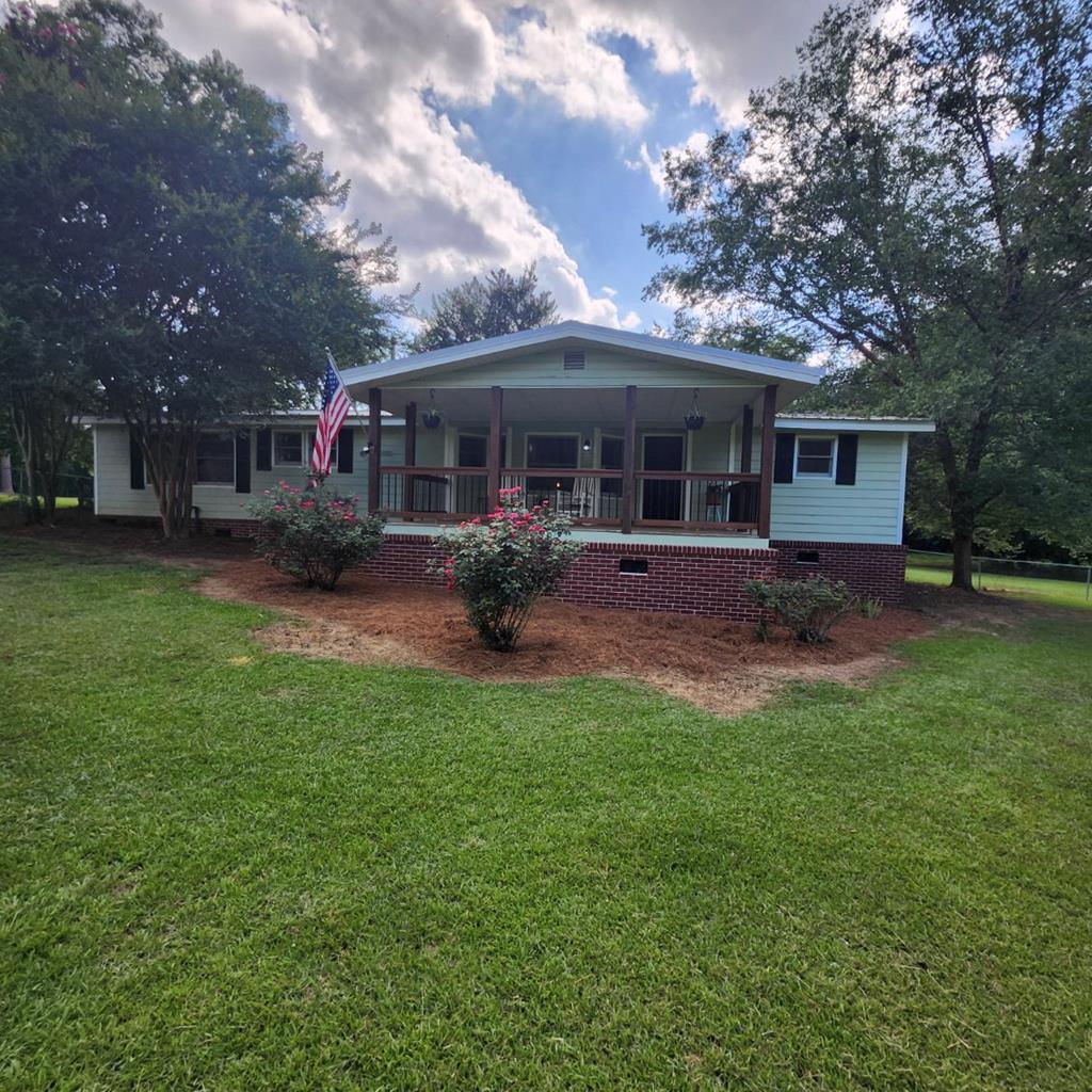 Acreage in Town! STUNNING Remodeled Home on 3.13 Acres!  Welcome home to the perfect blend of country freedom and city convenience! Nestled within the city limits of charming Doerun, this gorgeous 3-bedroom, 2-bathroom mobile home has been completely and beautifully remodeled from top to bottom. Step inside to discover a bright, modern interior featuring spacious living areas and stylish finishes. The thoughtful split-bedroom floor plan provides ultimate privacy for the primary suite. Sip your morning coffee on the inviting covered front porch, or host epic weekend barbecues on the expansive back deck. The real showstopper is the massive 3.13-acre lot. It features partial fencing, mature trees, and endless space for gardening, pets, or outdoor activities. Enjoy the luxury of sprawling acreage without sacrificing the benefits of city utilities and close proximity to town. Turn-key properties with this much land rarely hit the market—schedule your private tour today!