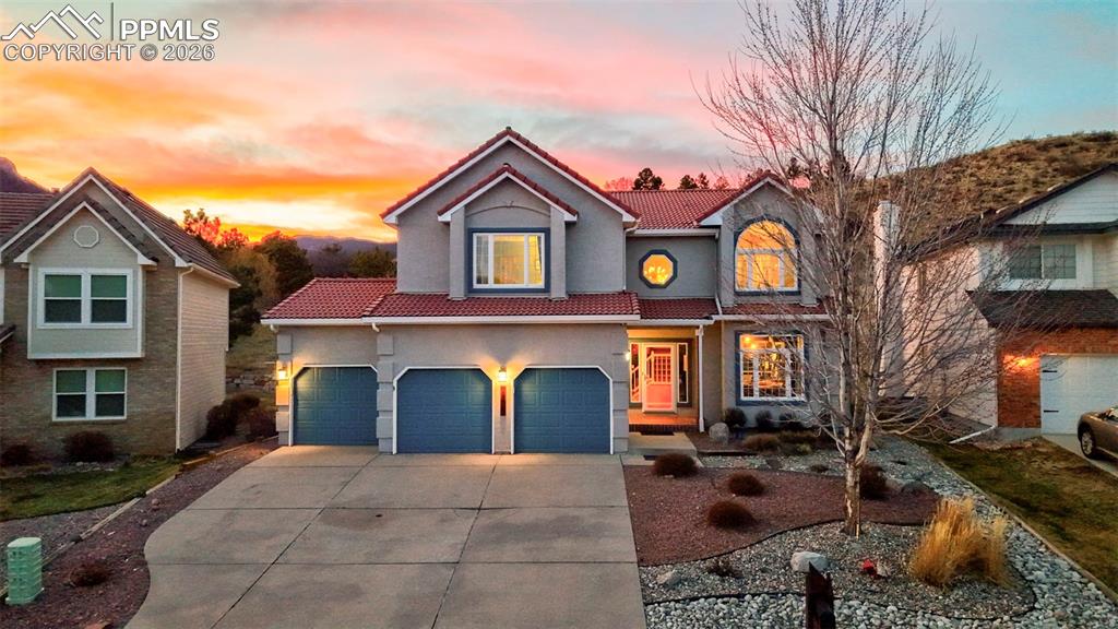 Discover serene privacy at the end of a quiet cul-de-sac in the coveted Peregrine neighborhood. This beautifully updated home backs directly to open space—a tranquil hillside that envelops the property in natural seclusion, with nearby trails inviting effortless foothills exploration—all within acclaimed District 20.The main level impresses with soaring vaulted ceilings, timeless crown molding, and gleaming refinished Brazilian Tigerwood floors throughout. Triple-pane windows flood every space with abundant natural light. Distinct yet harmonious living areas include a formal living room, dedicated dining room, cozy fireplace family room as the heart of the home, and a private office. At the center lies the chef-inspired gourmet kitchen, featuring high-end appliances, custom cabinetry, sleek quartz countertops, a generous center island, expansive walk-in pantry, and a welcoming coffee/dry bar with beverage refrigerator—ideal for daily living and sophisticated entertaining. Retreat to the luxurious primary suite, offering a spacious, light-filled bedroom and a spa-like 5-piece bathroom complete with double vanities and a deep soaking tub, creating your true private oasis for relaxation and rejuvenation. The thoughtfully finished basement provides versatile space for recreation, guests, hobbies, or a media room. Outside, the exclusive backyard sanctuary backs to open space and features a covered patio with permanently installed natural gas heaters for comfortable year-round enjoyment in peaceful surroundings. The expansive three-car garage includes EV charging and built-in workspace/storage. A masterful blend of timeless sophistication, modern refinement, and the quiet intimacy of Colorado foothills living—perfectly positioned near trails, parks, the Air Force Academy, and urban conveniences.