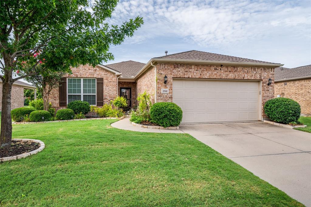 Welcome to 2941 Oyster Bay Drive in the vibrant active adult community of Frisco Lakes by Del Webb, where every day offers the opportunity to live well, stay active, and enjoy a true sense of community.  This beautifully maintained Copper Ridge floorplan is designed for both comfort and ease, offering two bedrooms, two bathrooms, and a versatile flex space that can serve as a home office, hobby room, reading nook, or additional guest area. The open concept layout is filled with natural light and creates a welcoming flow between the kitchen, dining, and living spaces, making it easy to host friends, gather with family, or simply enjoy a quiet morning at home.  The covered back porch offers a peaceful outdoor retreat, perfect for relaxing with a cup of coffee or enjoying a pleasant evening breeze. The landscaped front yard adds attractive curb appeal while supporting the low maintenance lifestyle that makes this community so appealing.  Life in Frisco Lakes is about far more than just the home itself. Residents enjoy access to an impressive array of amenities designed to support an active and connected lifestyle. Three resort style pools, a large indoor pool, three fully equipped fitness centers, and an indoor walking track make it easy to prioritize health and wellness. Pickleball and tennis courts, miles of walking and biking paths, and the lively Village Center provide endless opportunities for recreation, social gatherings, clubs, and community events.  2941 Oyster Bay Drive offers the chance to enjoy a beautifully cared for home while embracing a lifestyle centered on connection, activity, and the freedom to spend your time doing what you enjoy most.