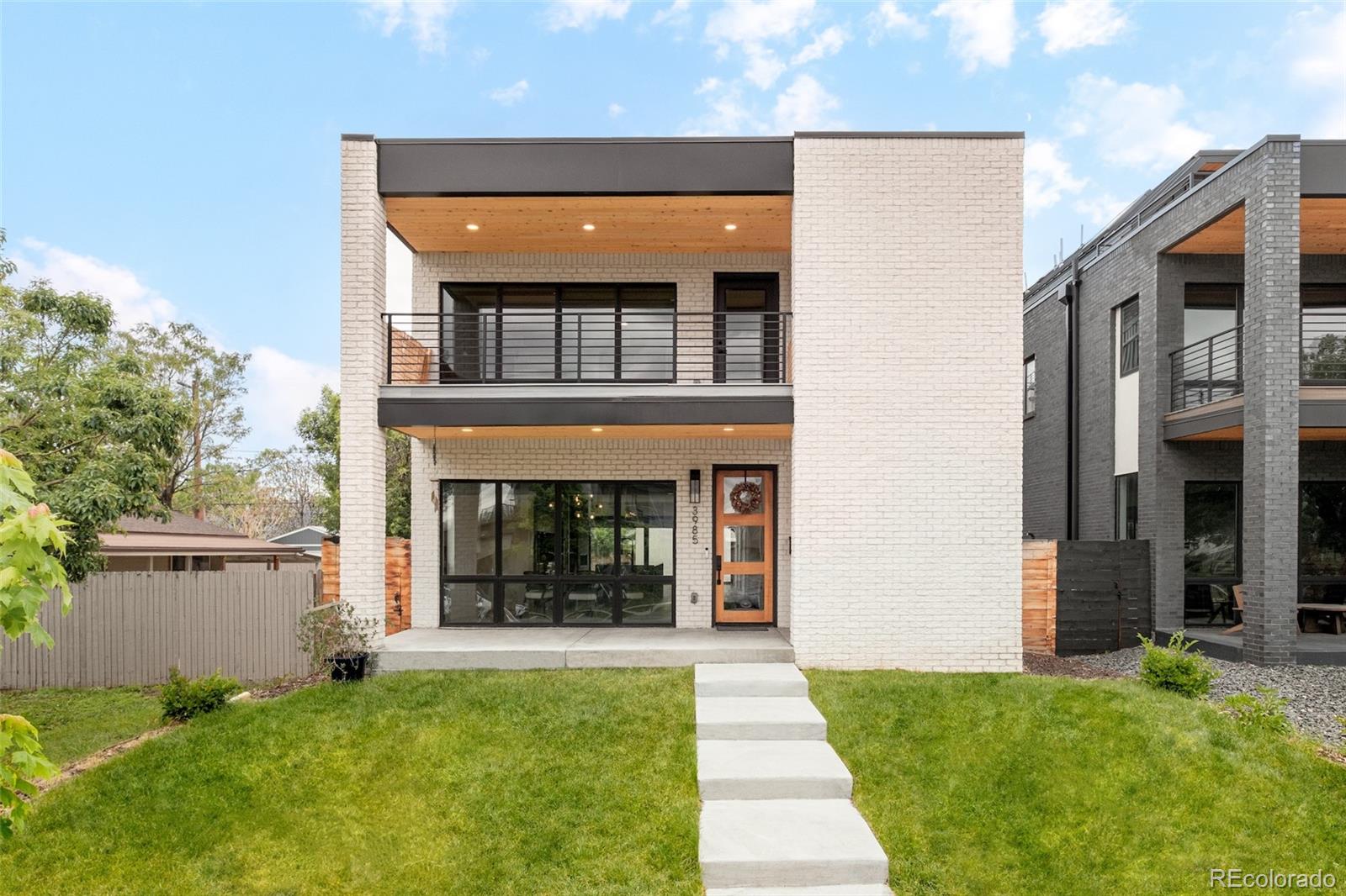 3985 Mariposa Street occupies a poised position in the Denver market that does not come available often: a home of genuine architectural scale and uncompromising finish quality, situated at the center of one of the city's most convenient and authentically evolving neighborhoods. The difference from nearby listings is felt immediately. The open main living area is more generous than anything comparable in the area, and the kitchen is outfitted with Vonmod cabinetry, Arhaus lighting, luxury appliances, and materials selected for both longevity and aesthetics. Floor-to-ceiling accordion doors dissolve the boundary between the living room and the backyard, delivering the indoor-outdoor connection that most buyers hope for but few homes actually achieve. Two rooftop balconies frame the full sweep of the Denver skyline, providing private vantage points for everything from quiet sunrise mornings to Fourth of July fireworks. The primary bedroom extends the experience with its own private balcony and a designer five-piece bath. The top-floor office, served by a dedicated mini-split system and its own attached bath, operates as a world apart from the rest of the house. The guest accommodations are serious by any measure. Generous bedrooms, en-suite bathrooms, and kitchenettes on both the basement and top levels mean that guests leave feeling properly hosted. Outside, a backyard fireplace nook, comprehensive landscaping and irrigation, and a covered front porch complete a residence that has considered every hour of the day and planned accordingly. The Wolf's Tailor, Wildflower, Nozomi and all of LoHi are walkable. Light rail to Union Station and DIA is five minutes on foot. The Platte River trail is accessible by bike in under fifteen minutes. All major systems are three years old or newer, and there is no HOA. Denver homes that combine exceptional finishes, a thoughtfully expansive footprint, and a location this convenient are genuinely rare. This one is available now.
