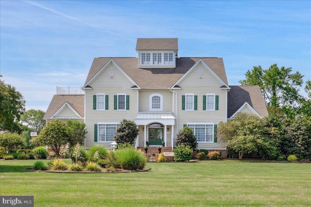 Experience Coastal Luxury at Its Finest! Welcome to South Point's Premier Waterfront Retreat—a showstopping waterfront estate where timeless elegance meets resort-style living. Positioned on 4.88 meticulously landscaped acres, this 5-bedroom, 6-bath custom masterpiece spans nearly 9,000 sq ft and captures unobstructed sunrise views across Sinepuxent Bay to Assateague Island.A sweeping paver driveway leads to a residence designed with distinction—offering complete privacy, grand entertaining spaces, and refined comfort throughout. Outdoors, indulge in your own private sanctuary featuring an infinity-edge pool with integrated hot tub, a fully equipped summer kitchen, and a lighted pier with boat and jet ski lifts—perfect for unforgettable gatherings or peaceful waterfront relaxation.Inside, no detail has been overlooked. The gourmet chef’s kitchen boasts custom cabinetry, granite countertops, and dual dishwashers, flanked by formal and casual living areas. A theater room, billiard lounge, wet bar, and home office provide the ultimate in luxury living. The top-level primary suite is a serene escape with a spa-inspired bath, oversized walk-in closet, and private balcony overlooking the bay.An elevator services all levels for seamless accessibility. Additional features include a 3-car garage with prep kitchen, solar panels, upgraded Wi-Fi speaker system, and an encapsulated crawlspace. This is a rare opportunity to own one of South Point’s most exclusive waterfront estates—where sophistication, comfort, and natural beauty converge.
