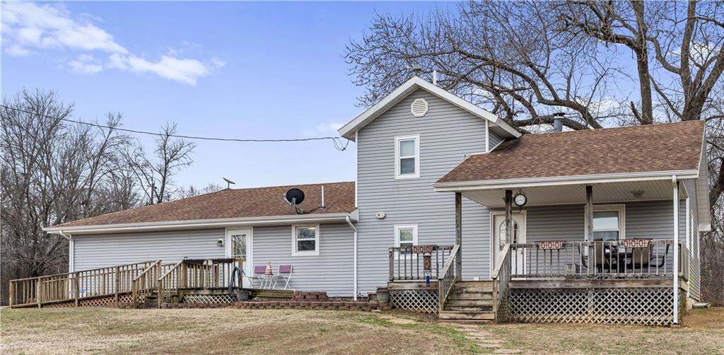 This 2,100+ sq. ft. traditional 1.5-story home offers 4 bedrooms, 2 full baths, and 2 half baths on 39+ scenic acres. The home features spacious rooms, formal dining, and an updated kitchen with modern appliances and solid surface countertops that opens to the living area for comfortable, open-concept living. The primary suite provides ample storage and space, while the master bath includes a standalone shower and jetted soaking tub.Outdoor improvements include a large deck, 30x30 red iron carport with metal roof, and an approximately 32x60 red iron barn with a 32x20 finished game room or office area. The property also features a custom welded pipe corral, chicken coop, and is fenced and cross-fenced with much of it in woven wire.The acreage offers a strong mix of pasture and timber, a nice pond, and abundant deer and turkey. Ideal for livestock, recreation, or hunting, this property delivers the complete country lifestyle.