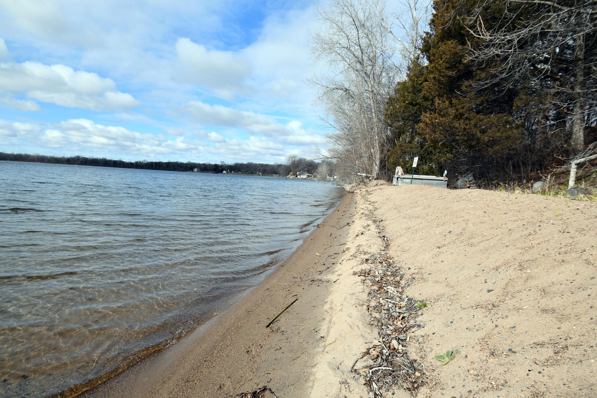 Welcome to the most exceptional location on Green Lake. Nowhere else will you find a beach like the peninsula at the end of Point Pleasant Road. This rare 1.5-acre sanctuary offers over 600 feet of pristine sand shoreline on Big Green Lake and an additional 700+ square feet of lakeshore on Little Green Lake. Owned by the same family for more than a century, the property is private, wooded, and surrounded by water views on three sides.A peaceful walking trail leads to the tip of the point, where you’ll encounter nesting turtles, blue herons, loons, and other wildlife. The original 1910 cottage remains, featuring an expansive wraparound three-season porch perfectly positioned to take in the views. An oversized garage includes a spacious workshop for storage or hobbies.Whether you envision a charming summer retreat or the site of your future dream home, this property offers unmatched beauty and seclusion on Big Green Lake—part of the Chisago Lakes Chain—just 45 minutes from Minneapolis and St. Paul and 5 minutes to restaurants and shopping. City water and Sewer and high-speed internet.