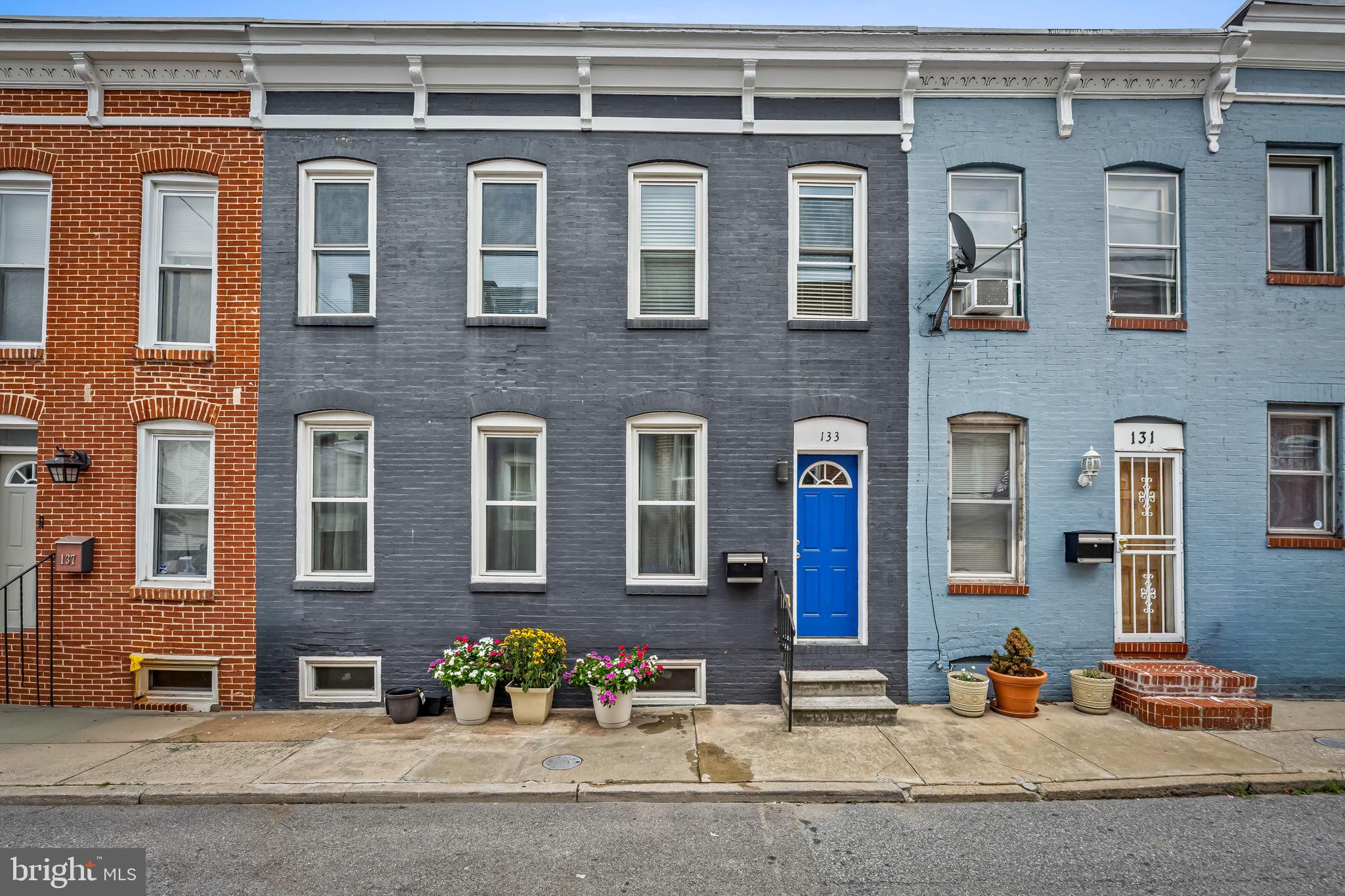 Exceptional Properties. Exceptional Clients. Rarely available in Patterson Park, this expansive home was created by thoughtfully combining two historic Baltimore rowhomes into one remarkable residence. Offering 4 bedrooms, 4 full bathrooms, private 2-car parking, and an unusually wide floor plan, this freshly painted home blends historic charm with the space and convenience of modern living.Inside, exposed brick walls, generous living spaces, and abundant natural light create a home unlike the typical city rowhouse. The spacious living room is anchored by a stunning exposed brick fireplace, while the oversized kitchen features an expansive butcher-block island with seating for family and friends, creating an ideal space for gathering and entertaining. Stainless steel appliances, fresh paint, and dual-zone HVAC combine modern comfort with timeless Baltimore character.The highly desirable main-level bedroom and full bathroom offer remarkable flexibility as a guest suite, home office, or multigenerational living space. Upstairs, spacious bedrooms and multiple full baths provide room for everyone without sacrificing privacy.Outside, enjoy the rare convenience of off-street parking for two vehicles. Just steps away, Patterson Park offers miles of walking and biking trails, a swimming pool, tennis courts, a dog park, playgrounds, athletic fields, and year-round community events. Johns Hopkins Hospital, Canton, Fells Point, Harbor East, and downtown Baltimore are all just minutes away.A one-of-a-kind Patterson Park home offering exceptional space, timeless character, and modern convenience in one of Baltimore's most sought-after neighborhoods.