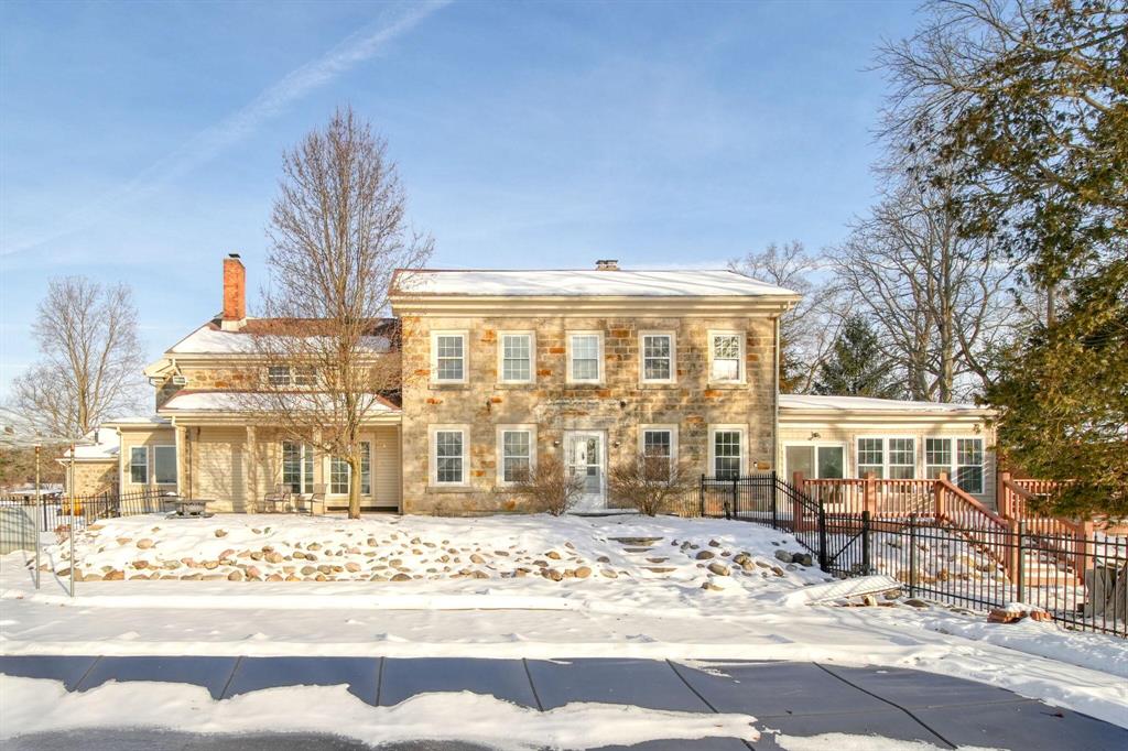 The stunning Glasgow federal stone estate set on 6 breathtaking acres in Western School District--an incredible opportunity offering exceptional value for a property of this caliber. Rich in character and craftsmanship, the main home features 5 bedrooms, 2.1 baths. Multiple inviting living spaces include a recently finished vaulted media/family room with gas stove, library with custom built-ins, elegant parlour with fireplace, completely renovated 3/4 season room, and flexible bonus space. The updated cherry kitchen with granite counters opens to a sunlit breakfast nook overlooking acreage and the sparkling in-ground saltwater pool. Formal dining showcases hardwood floors and a statement fireplace.With extensive mechanical updates completed (list available) the heavy lifting has been done--allowing buyers to add personal touches while enjoying immediate comfort  in this one-of-a-kind property offering a multitude of possible use options. The fully remodeled 2-bedroom guest househas an appealing 1250.5 square foot open floor plan and amazing stone fireplace. One of Jackson County's most iconic barns with stone silo has been recently stained and a new metal roof and barn rail door installed. The "chicken coop"/workshop, re-sealed sports court, peace of mind generators at both homes & 3-bay stone carport complete this extraordinary property. Added convenience of location, minutes to M-60 & I-94 for commuters.