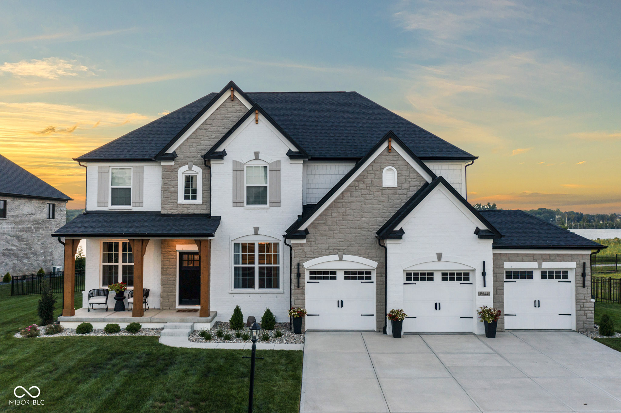DEEDED BOAT DOCK + MOVE-IN READY NEW CONSTRUCTION - Enjoy all the perks of building without the wait, decisions, or delays. This custom home in the highly sought-after Springs of Cambridge offers premium waterfront living on Geist Reservoir with unobstructed views and no homes behind.    Step inside to soaring ceilings, an open-concept layout, and designer finishes throughout. The great room is filled with natural light and flows seamlessly into the dining area and chef's kitchen, complete with quartz countertops, double ovens, and a walk-in pantry. Step outside to the covered back patio with a cozy fireplace-the perfect place to unwind and watch the sunset over the water.    Upstairs, the primary suite is a true retreat featuring a tray ceiling, peaceful water views, and a spa-like bath with double vanities, large shower, and a spacious walk-in closet. Three additional bedrooms upstairs include walk-in closets and bathroom access, plus the convenience of a second-floor laundry room.    The finished basement offers even more space to relax or entertain, with a large rec room, full bath, and a 5th bedroom-perfect for guests or multigenerational living. The fully fenced backyard is pool-ready and ready for your dream outdoor setup.    With a deeded boat dock (#447) just steps away and access to parks, restaurants, and top-rated schools, this is Geist living at its finest-luxury, location, and lifestyle in one exceptional home.