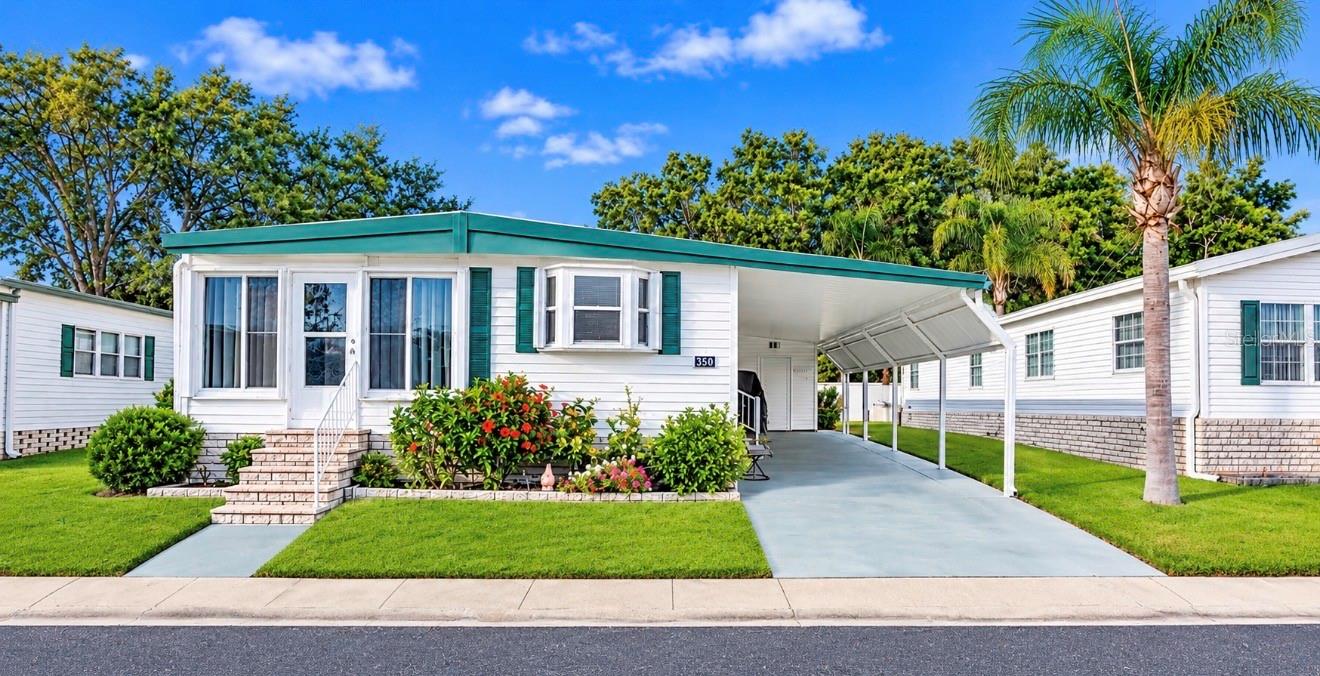 WELCOME TO YOUR FLORIDA RETREAT IN THE HIGHLY DESIRABLE FAIRWAY VILLAGE 55+ COMMUNITY—WHERE COMFORT, STYLE, AND RESORT-STYLE LIVING COME TOGETHER! Discover this beautifully maintained 2-BEDROOM, 2-BATHROOM HOME, perfectly positioned on an elevated lot and offering wonderful improvements, spacious living, and the convenience of being FULLY FURNISHED AND MOVE-IN READY! Whether you're seeking a seasonal getaway or a year-round residence, this inviting home checks all the boxes! IMPRESSIVE CURB APPEAL AND OUTDOOR ENJOYMENT! An extended driveway provides generous parking, while a charming sitting area at the rear of the home offers the perfect retreat for morning coffee, afternoon relaxation, or entertaining friends. Attractive vinyl siding, newer windows with locking hurricane shutters, and a METAL ROOF-OVER (2011) add to the home's appeal. Whole house water softener and the air conditioning system has been regularly serviced and maintained. STEP INSIDE AND FEEL RIGHT AT HOME! A welcoming OPEN-CONCEPT FLOOR PLAN seamlessly connects the living room, dining area, and kitchen, creating a comfortable setting for everyday living and gatherings. Tile and laminate flooring with plywood underlayment provide an attractive, practical foundation throughout. A KITCHEN THAT TRULY SHINES! Beautiful GRANITE COUNTERTOPS, a decorative tile backsplash, and convenient appliance garages offer the perfect combination of style and functionality. Enjoy generous workspace, organized countertops, and an open design that keeps you connected to guests while preparing your favorite meals! TWO COMFORTABLE BEDROOMS with walk in closets AND TWO REFRESHED BATHROOMS! Both bathrooms feature tasteful improvements, including updated countertops, sinks, and attractive backsplashes. With furnishings included, you can settle right in and immediately begin enjoying your new Florida lifestyle! OWN A PIECE OF PARADISE—LAND SHARE INCLUDED! Fairway Village is a desirable 55+ RESIDENT-OWNED COOPERATIVE COMMUNITY known for its beautifully maintained surroundings, pride of ownership, friendly atmosphere, and outstanding amenities. The valuable CO-OP LAND SHARE is INCLUDED in the purchase price! RESORT-STYLE AMENITIES RIGHT OUTSIDE YOUR DOOR! Experience the exceptional 19,000+ SQ. FT. CLUBHOUSE, challenging 9-HOLE PAR-3 GOLF COURSE, TWO SWIMMING POOLS AND SPAS, eight covered shuffleboard courts, fitness center, billiards room, library, and a fantastic variety of community activities and social events. There's always something to enjoy! AFFORDABLE AND CONVENIENT LIVING! The monthly maintenance fee of just $420 includes WATER, SEWER, GARBAGE, LAWN MAINTENANCE, BASIC CABLE, AND INTERNET! Conveniently located in Largo, you're just minutes from shopping, restaurants, medical facilities, airports, and the spectacular GULF COAST BEACHES! DON'T LET THIS ONE GET AWAY! With its desirable updates, welcoming floor plan, included furnishings, valuable land share, and incredible community lifestyle, this home offers a wonderful opportunity to enjoy everything Florida living has to offer. SCHEDULE YOUR PRIVATE SHOWING TODAY! Home details, measurements, improvements, ages of components, furnishings, and community information are believed accurate but are not guaranteed. Buyers should independently verify all information and conduct any inspections deemed necessary.