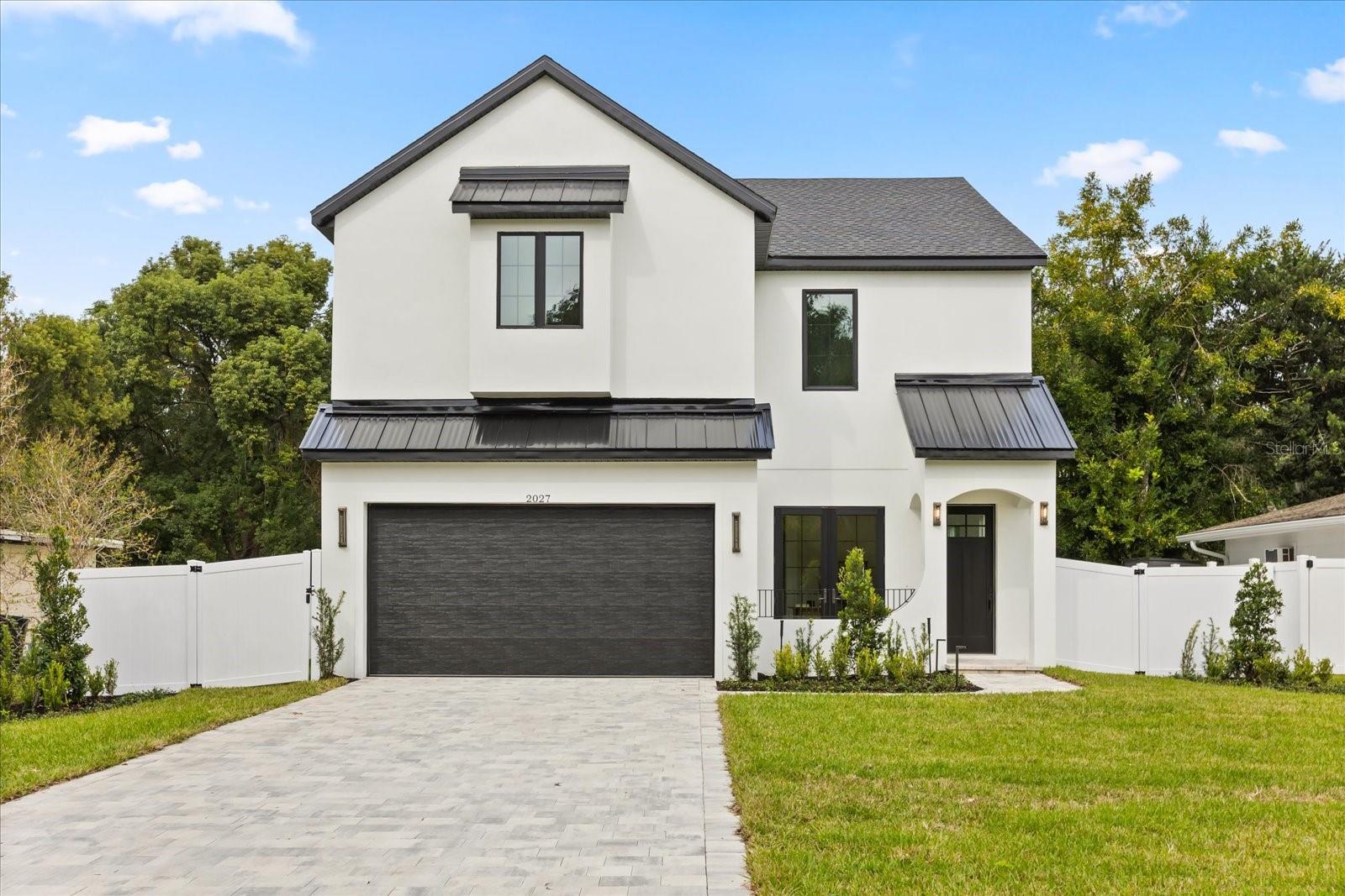 Step inside and discover a home designed for connection, comfort, and modern living. Natural light fills the open-concept main floor where a chef-inspired kitchen with a pot filler, oversized island, and top-tier appliances becomes the heart of the home. The living and dining areas flow seamlessly, creating a warm, social space perfect for gatherings large or small.

Tucked just off the entry, a stylish office and full bath add flexibility for guests or working from home. Upstairs, a spacious loft and family room provide room to unwind, while the luxurious primary suite feels like a private retreat with a spa-style bath featuring dual vanities, soaking tub, and an oversized wet room shower. Two additional bedrooms share a beautifully designed Jack and Jill bath.

Enjoy peaceful mornings on the inviting front porch or end your day on the covered back patio overlooking the fenced, manicured yard. With thoughtful details like a wine fridge and dry bar, tray ceilings, and high-end finishes throughout, this move-in-ready 2025 new build blends everyday function with modern elegance, just minutes from the heart of Orlando’s sought-after SODO district, dining, and parks.