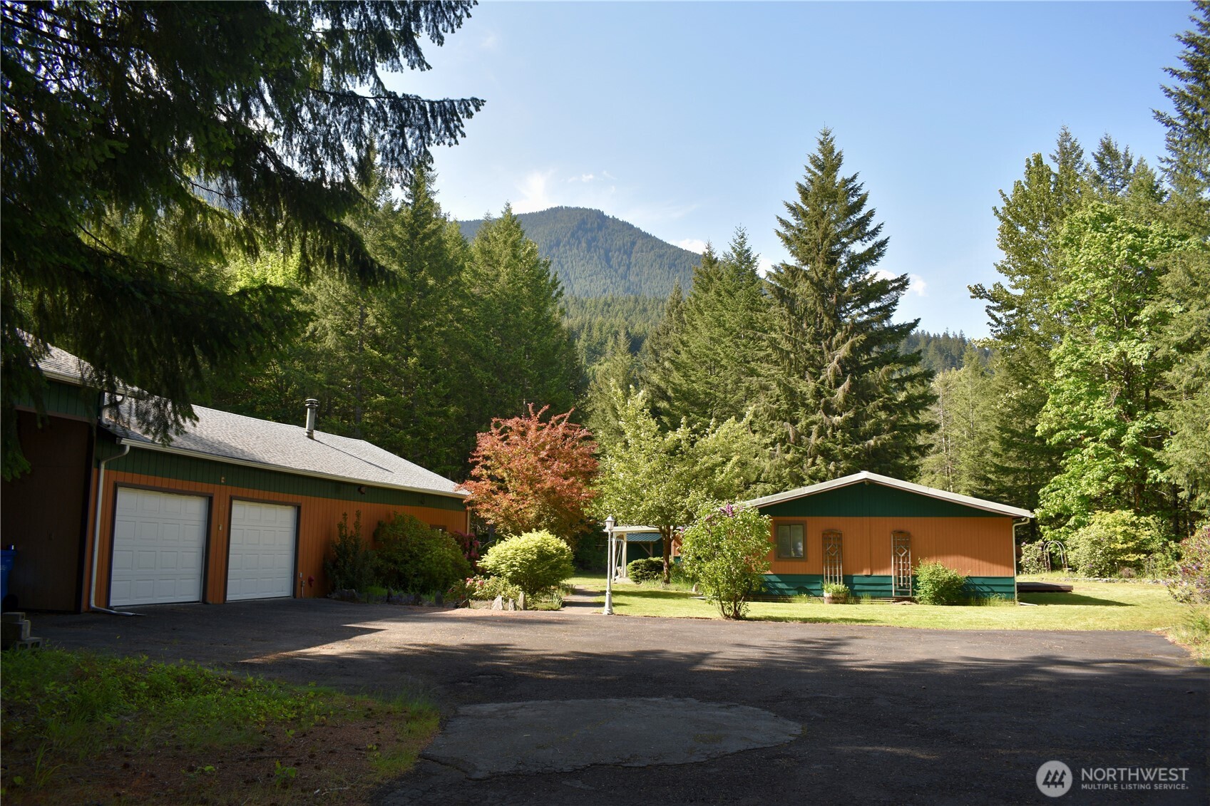 Welcome to Packwood, an outdoor enthusiast dreamland, nestled in the majestic White Pass! This sold "as is" 2093 sq. ft. fixer upper-gem is located on 2.87 acres with a beautiful view of Butter Butte, as well as a large 1800 sq. ft.  multi-bay garage/ shop with RV parking, a 1/2 bath and a wood stove. The back entrance is the main access point to the house, with its large multi-purpose mud-room, attached to a laundry room and full bath that is accessible by 1 of the 3 bedrooms. The spacious kitchen opens up to a family room with a wood stove. The living room has wall -to- ceiling windows and attached is additional room perfect for an office/den or crafts area. The owner's suite is attached to an unfinished master bath.