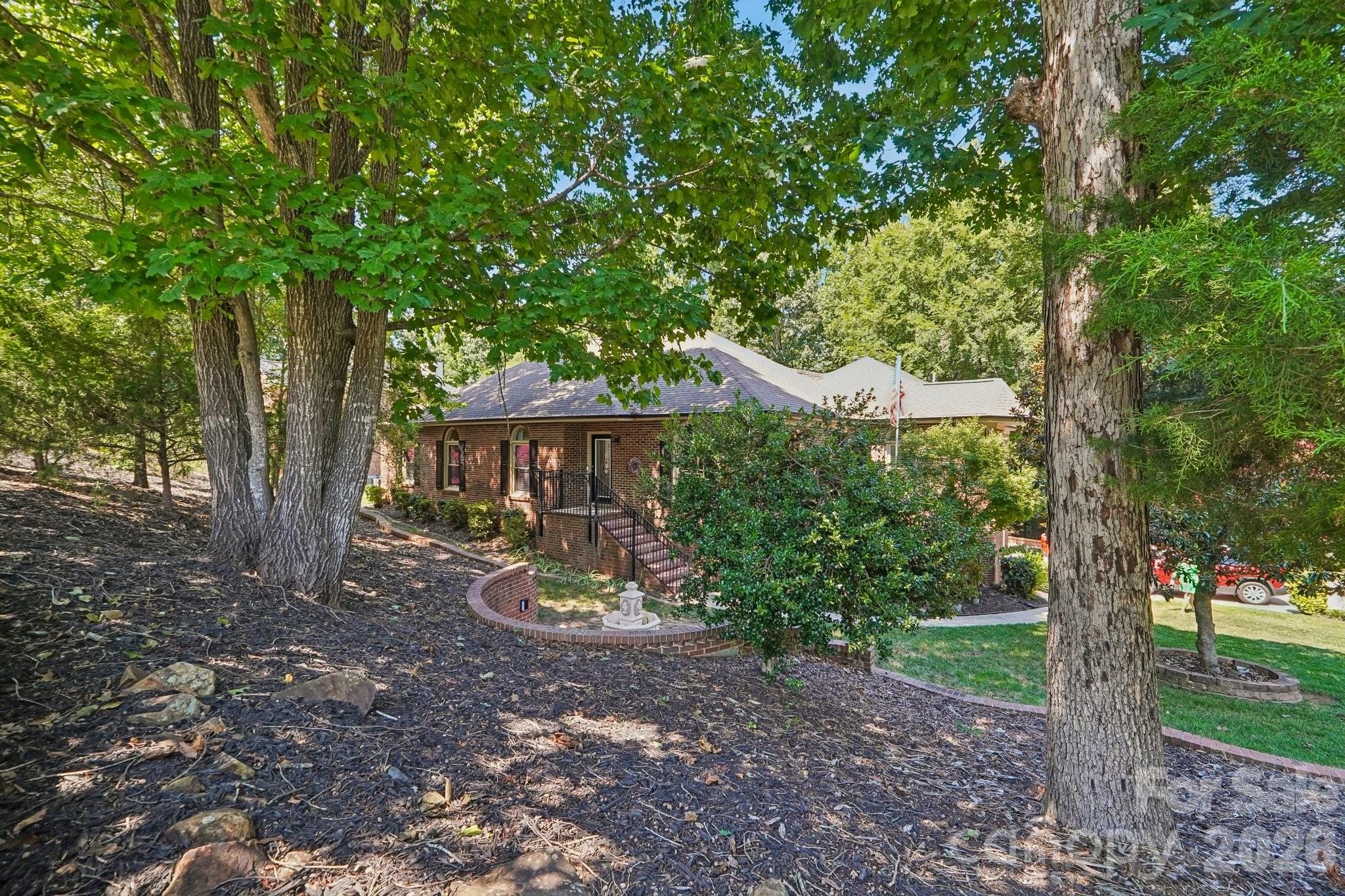 ONE OF A KIND - Unmatched Craftsmanship & Generational Living in HarrisburgCustom-renovated from top to bottom, this brick ranch with a partially unfinished basement offers luxury, space, and ultimate versatility. Tucked away on a quiet corner on double cul-de-sac streets, every inch of this home has been thoughtfully redesigned. MAIN LEVEL LIVING - Step through the marble-tiled foyer into a open concept featuring custom dome ceilings with statement lighting in several rooms along with sleek modern glass sliding doors throughout. The chef’s KITCHEN is a standout, equipped with custom soft-close cabinetry, under-cabinet lighting, lit glass accent displays, granite countertops, tile flooring, stainless steel appliances, a central island and breakfast area. You can host effortlessly in the formal DINING ROOM right next to kitchen. Work from home in the private, hardwood-floored OFFICE. The PRIMARY SUITE is a private retreat featuring decorative wall molding, hardwood floors. PRIMARY SUITE BATHROOM is beyond resort-style it was spa like, dome ceiling with exquisite chandelier, all-glass seamless shower with body jets, an Aquatic infinity jetted tub with changing ambient lighting around tub surround, and a custom walk-in closet system. Endless Entertainment opportunities with massive BILLIARDS/GAME ROOM with an elevated bar area or play zone (this area was added but NOT permitted 688 square feet NOT counted in total HLA) FAMILY ROOM is a warm room anchored by an electric fireplace, vaulted ceiling and built-in cabinets looking into kitchen area, SECONDARY BEDROOMS one with walk-in closet and both with hardwood flooring, main bath with jetted tub, and new cabinets with dual sinks. Full SECONDARY LIVING SUITE complete with its own kitchen with tons of cabinets, den, office or sitting room, primary suite with walk-in closet, and full bath with jetted tub and custom cabinets and custom tile work—ideal for multi-generational living or income potential. BASEMENT AREA - The Ultimate Workshop & Outdoor Haven - Hobbyists will love the oversized workshop in the basement, featuring epoxy floors, 220V power, ramp access entering basement shop area through a custom barn door, workshop deep sink in garage, an office room heated and cooled by upstairs along with half bath (NOT counted in HLA) this basement is perfect for handyman, mechanic or carpenter. OUTDOOR RETREAT, relax on the expansive circular style vinyl deck with wrought iron railings and integrated low-voltage lighting overlooking a private, tree-lined yard. KEY UPGRADE: Newer Modern Pella & Andersen high-efficiency windows in several areas, tankless water heater, whole-house water softener, gutter guards, outdoor lighting on exterior of home, custom laundry room with folding station, decorative retaining wall in front yard, both refrigerators to be included. This home is loaded with storage space. Extra drivieway parking area and plenty of extra concrete under elevated deck. This house loaded with extra's. Small subdivision in Harrisburg with NO HOA's