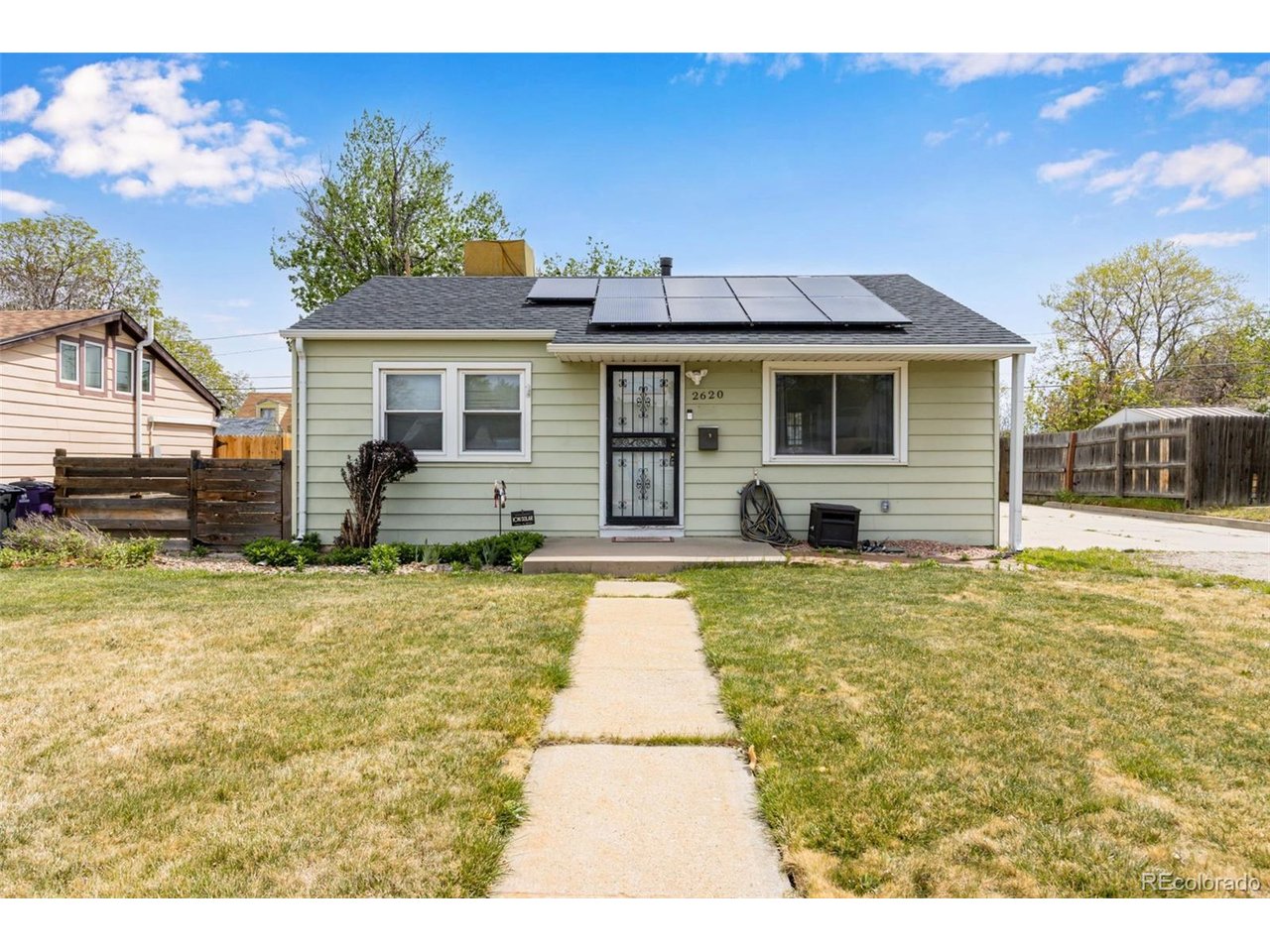 Welcome to this charming ranch-style home in the desirable Harvey Park neighborhood! This well-maintained 2-bedroom, 1-bath home offers comfort, efficiency, and thoughtful updates throughout. Step inside to find beautiful hardwood floors and a warm, inviting layout. The kitchen comes fully equipped with included appliances and a gas stove, making it both functional and ready for everyday living. Enjoy Colorado living year-round with a covered patio-perfect for relaxing or entertaining. The oversized 2-car heated garage features new siding (just 2 years ago), offering both convenience and durability. This home is packed with valuable upgrades, including a fully paid-off Ion Solar system for little to no electric bills, extra attic insulation for energy efficiency, newer windows, a boiler (7 years old), hot water heater (2 years old), and a new roof (2 years old). Additional features like a water softener and leaf guards on the gutters add to the home's ease of maintenance. Ideally located near Loretto Heights College and Bear Valley Shopping Center, you'll enjoy easy access to shopping, dining, and amenities while living in an established, sought-after neighborhood.This is a fantastic opportunity to own a move-in ready home with major systems already updated-don't miss it!