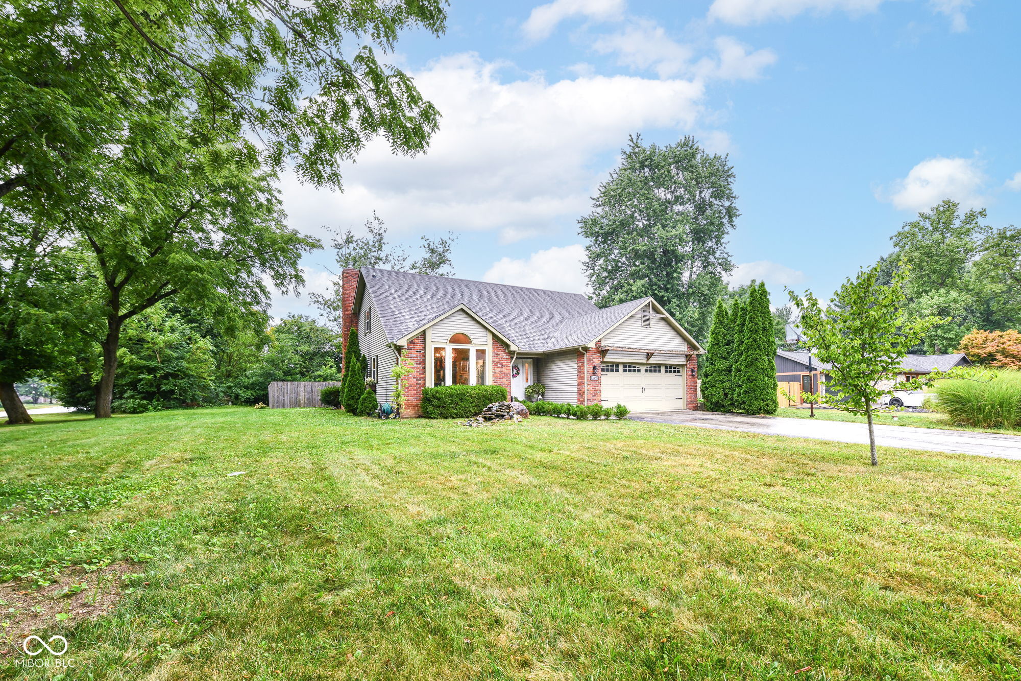 Updated 1- 1/2 story custom Carmel home sitting on 1/2+ acre lot with a beautiful view overlooking the Twin Lakes golf course.  Meticulously maintained.  The best thing is this house is NOT in a subdivision!!!  This beautiful home is owned by the original owners and features an updated kitchen with solid cherry cabinets, granite counters, a pantry and newer s/s appliances. Windows were just replaced in 7/2026.  Main level features 3 bedrooms (including one primary bedroom with on suite bath) and another full bath.  Upstairs features custom welded wrought iron railings, a loft/office area and a second primary bedroom/bath with beautiful marble walk in shower and ample attic storage.  The Living room features cathedral ceiling and a woodburning fireplace with fireplace insert which can help heat the house during the winter.  The back yard features a deck overlooking the newer fenced back yard ample for entertaining.  A chicken coop and chickens come with the house but will be removed by the owner if it's not wanted by the new buyers.   Great opportunity to own an affordably priced home located with a beautiful golf course view, near multiple gated communities and with NO HOA FEES.