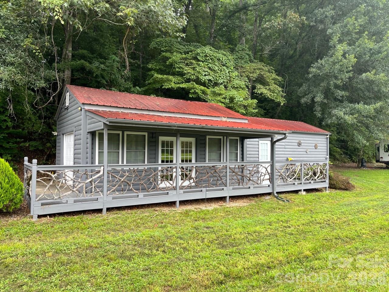 No Deed restrictions. Short term rentals allowed. Studio/home, commercial, retail, residential, multi-family, r/v park, medical, manufacturing, auto service and sales lot ETC. allowed! Circular road across the top of the property for additional residential or commercial buildings with beautiful 180 degree south views to the mountains with million+ dollar homes across valley. 575 feet of road frontage on Cane Creek Road with multiple entrances and exits. Great site visibility for signage. Previously leased for stain glass studio, medical center/physical therapy, residential studio home, warehouse, auto body, auto sale lot and r/v sites.  Currently rented month to month for $1500 (building) and $600 (camper lot). Another camper site available along road and homesite with spectacular view on upper trail. Owner/Broker