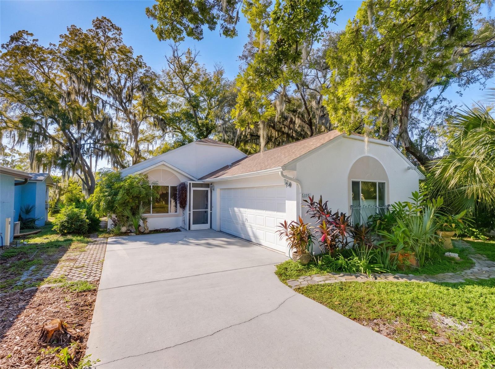 Enjoy the best of Downtown New Port Richey while coming home to your own private retreat! Tucked back from the street, this 1,748-square-foot home welcomes you with high ceilings, French doors, and a flexible den that could become a third bedroom. The indoor laundry room adds everyday convenience, while appliances that are only a few months old are a welcome update. The beautifully landscaped backyard is a standout feature. Take in the peaceful, private setting from the spacious enclosed lanai, or unwind on the second lanai just off the dining area. A backyard shed offers extra storage.With Sims Park approximately half a mile away, the New Port Richey Recreation & Aquatic Center about 1.5 miles away, and shopping along US-19 and Gulf waterways nearby, there’s plenty to enjoy close to home. Golf carts are welcome, too! Schedule your showing and see this downtown gem for yourself.
