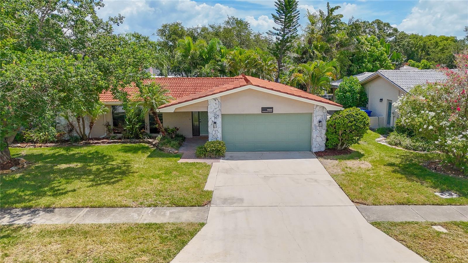 Rarely do you find a property that truly stops you in your tracks.  This stunning and sprawling four bedroom waterfront home emits a gracious, elegant, and lasting impression.  Ideally nestled in the sought after subdivision of El De Oro West, 1908 Sandpiper lays its claim with an impressive .33 acre lot alongside 80 linear ft of salt water canal frontage.  Perfect for large families and multi-generational living alike, the tri-split bedroom floorplan and three separate and large living spaces offer endless arrangements, multiple entertaining spaces, and privacy alike. Dual Master bedrooms with one offering beautiful water vistas and the other a spa worthy en-suite, both with walk-in closets.  This home has just undergone a complete and meticulous remodel including all new luxury vinyl plank flooring, 5 inch baseboards, high end lighting, and fresh interior paint throughout. The all new well equipped kitchen is central to the home and is a culinary dream. Adorned with level two Calcutta quartz countertops, soft close cabinetry, stainless steel appliances, butcher block floating shelving, and ample prep space. Open, light, and airy, the kitchen with pass-through, flows effortlessly from all three living spaces into a breakfast nook and dedicated dining room.  A bonus room caters to your needs and can be used as a theater room, craft room, office, or even made into a 5th bedroom or third bath.  Just beyond the dining room is a door that leads out to your professionally landscaped backyard oasis with a large composite patio overlooking the flowing water. A six zone irrigation system keeps your tropical plants and St Augustine grass thriving.  Built to stand the test of time with solid all block construction, tile roof, newer seawall, and many newer double pane low emissivity windows including an impact rated overhead garage door.  Live the Florida lifestyle with Kayak/small motor vessel access on Allen's creek with an array of game fish and marine life. Embark on a serene 45 minute paddle that winds along tropical flora and fauna guiding you all the way to the waters of Old Tampa Bay. This home's central location offers an easy drive to vibrant St. Petersburg, shopping, fine local fare, two international airports, championship caliber professional sports, and the world famous sugar sand beaches of the Gulf.