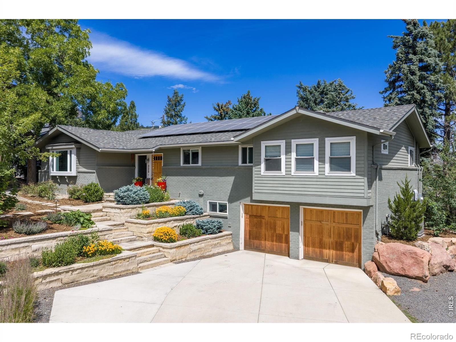 Nestled at the foot of the Flatirons in coveted Upper Table Mesa, this beautifully remodeled Mountain Sanctuary is perched in one of South Boulder's most sought-after locations. The thoughtfully updated interior features newly refinished hardwood floors, fresh paint, a tile entry, bay windows, and a gourmet kitchen gas stove, granite countertops, stainless steel appliances, pantry, and a wine bar that opens seamlessly to the living area-perfect for entertaining. The main level includes three bedrooms, two with an en-suite bath.Retreat to the luxurious primary suite featuring Flatiron views, a private balcony, a spa-inspired bath with radiant floor heating, Jacuzzi tub, walk-in shower, and an expansive custom walk-in closet with built-ins.The walk out lower level offers a large family/media room with cork flooring, a wet bar, and direct access to the lush backyard. Outdoor living is exceptional with beautiful decks, flagstone patios, extensive stone landscaping, and a stunning 4-person Finnish Thermory barrel sauna with panoramic rear window, WiFi-connected Huum Drop heater, and sauna rocks. Additional features include an owned 4.2kW solar system with remarkably low utility bills, two electric vehicle chargers, a newer high-efficiency furnace, new sewer line (2017), radon mitigation system, irrigation system, front-loading washer and dryer with laundry tub, extensive storage, two 50-gallon water heaters, and a spacious two-car garage with additional off-street parking for a van or camper. Enjoy direct access to hiking and biking trails, top-rated schools, Whole Foods, and easy commuting to Denver, DIA, and I-70.A peaceful mountain sanctuary offering luxury, sustainability, and the very best of Boulder living.