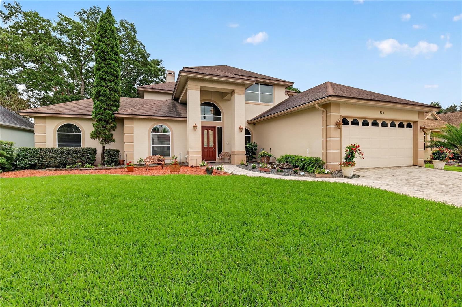 GOLF-FRONT POOL ESTATE IN THE COUNTRY CLUB OF MOUNT DORA Experience luxury golf course living in this exceptional 5-bedroom, 4-bath pool home, perfectly positioned on the second tee of the prestigious Country Club of Mount Dora golf course. Combining elegant design, generous living spaces, and beautiful views, this residence offers an extraordinary lifestyle in one of Central Florida's most sought-after communities. From the moment you arrive, the home's stunning curb appeal sets the tone. A beautifully manicured lawn, a custom paver driveway, an attractive stucco exterior, dramatic arched windows, and a covered entry portico create a memorable first impression. The spacious driveway, two-car garage, and separate golf-cart garage access provide ample parking and convenience. Step through the impressive leaded-glass front door into a light-filled interior highlighted by soaring ceilings, crown molding, and quality craftsmanship throughout. The elegant foyer is flanked by formal living and dining rooms featuring hardwood floors and custom faux-finished walls—ideal settings for entertaining and holiday gatherings. At the heart of the home, the open-concept family room and kitchen showcase spectacular views of the pool and golf course. A gas fireplace anchors the family room, while the chef's kitchen is designed to impress with 42-inch wood cabinetry, Corian countertops, a center cooktop island, stainless steel appliances, a French-door refrigerator, dual wall ovens, a walk-in pantry, an expansive breakfast bar, and a charming bay-window dining area overlooking the pool and fairway. A beautiful wood staircase leads to the private upstairs primary suite, a true retreat featuring hardwood flooring, two walk-in closets, and a luxurious en-suite bath with dual vanities, a soaking tub, and a separate shower. Step onto the screened balcony and enjoy panoramic views of majestic oak trees, the sparkling pool, tranquil pond, and lush golf course. A convenient stackable washer and dryer complete the suite. Two additional upstairs bedrooms share a full bath, while downstairs offers a versatile floor plan with a second en-suite bedroom/bathroom featuring direct pool access. A fifth bedroom can easily serve as a private home office and is conveniently located near another full bath. Additional features include a spacious main-living laundry room with a utility sink, storage, and a laundry chute. Outdoor living is equally impressive. The screened pool lanai is designed for year-round enjoyment and entertainment, featuring a fully equipped summer kitchen with a grill, sink, refrigerator, and ice maker. Whether hosting friends and family or enjoying a quiet evening overlooking the fairway, this outdoor oasis delivers the ultimate Florida lifestyle. Residents of the Country Club of Mount Dora enjoy access to an 18-hole championship golf course, clubhouse and restaurant, community pool, tennis and pickleball courts, walking trails, playground, and a vibrant social calendar. Ideally located just three miles from historic downtown Mount Dora, this home offers convenient access to shopping, dining, healthcare, and major highways, with Orlando, area attractions, and Florida's beautiful beaches all within approximately one hour. This is more than a home—it is a lifestyle. Discover golf-course living at its finest.
