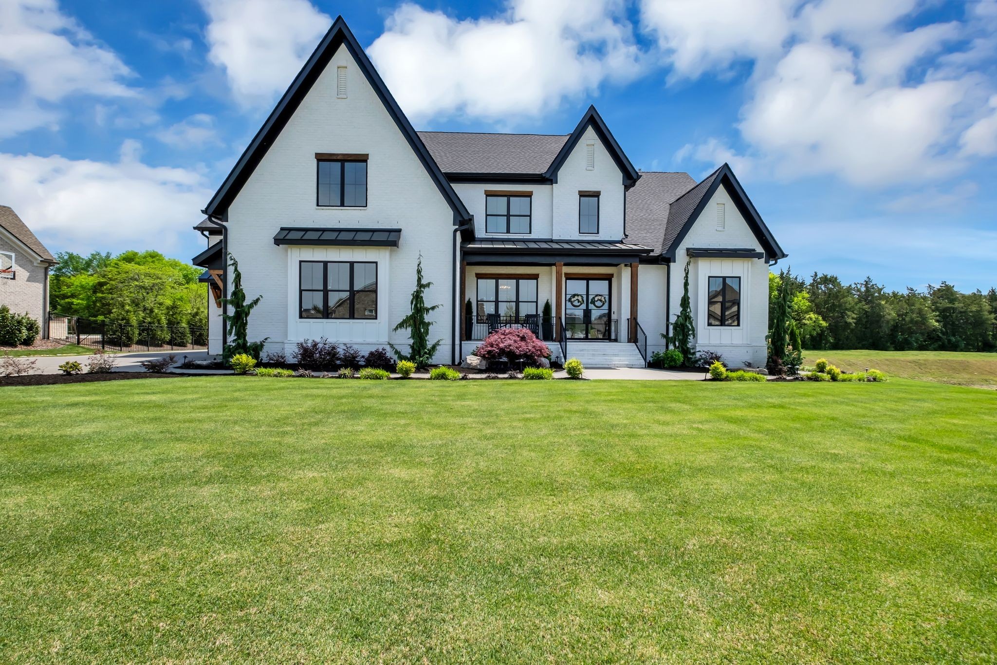 This exceptional, custom all‑brick residence blends craftsmanship, luxury, and thoughtful design across five bedrooms (two on the main level), four full baths, and two half baths just minutes away from the new Village Green and Publix Grocery. Full hardwood flooring and tile showers—with no inserts or pans—set a tone of quality from the moment you enter through custom iron doors leading to the entry, office, pantry, and laundry. The main living area centers around a gourmet kitchen with a fabulous 60" gas fireplace with an 8' white oak mantel, complemented by whole‑home speakers and a full security camera system. The chef’s kitchen is anchored by a 60" Thermador dual‑fuel range, matching 60" Thermador refrigerator and freezer, two Thermador dishwashers, a built‑in GE nugget ice machine, and elegant under‑cabinet and toe‑kick lighting. Motorized screens open to an oversized patio featuring a 54" gas/wood‑burning fireplace, built‑in Coyote gas BBQ and Coyote pellet grill, and a custom quartz fire pit—perfect for elevated outdoor living. The primary suite offers wood shutters, motorized screens, and an oversized wet‑room shower. Upstairs includes built‑in bunk beds, an LG washer/dryer, and a bonus room. Outside, the fully landscaped and irrigated yard includes extensive concrete walkways, additional parking, and a fully fenced backyard. A Caldera Spa, storm‑safe shelter, and fully coated oversized 3‑car garage complete this rare offering. Community amenities include garden and soccer field as well.