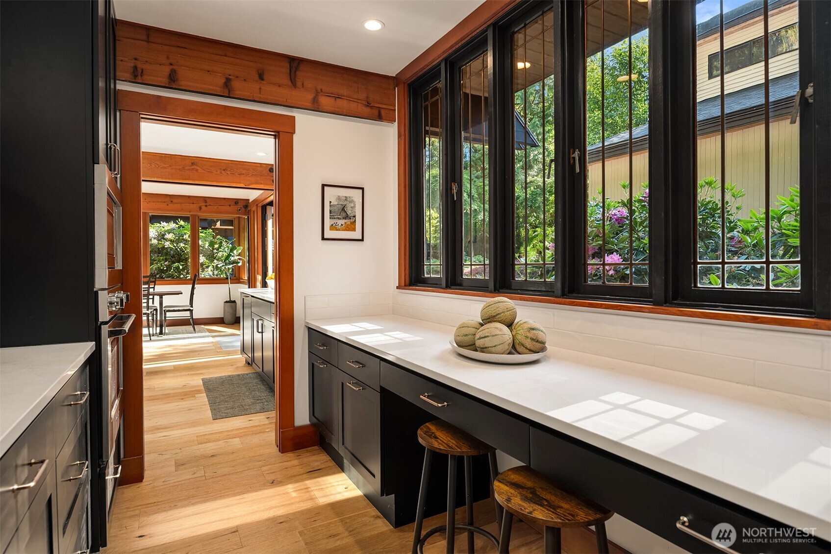 Charming butler's pantry with prep counter and garden view