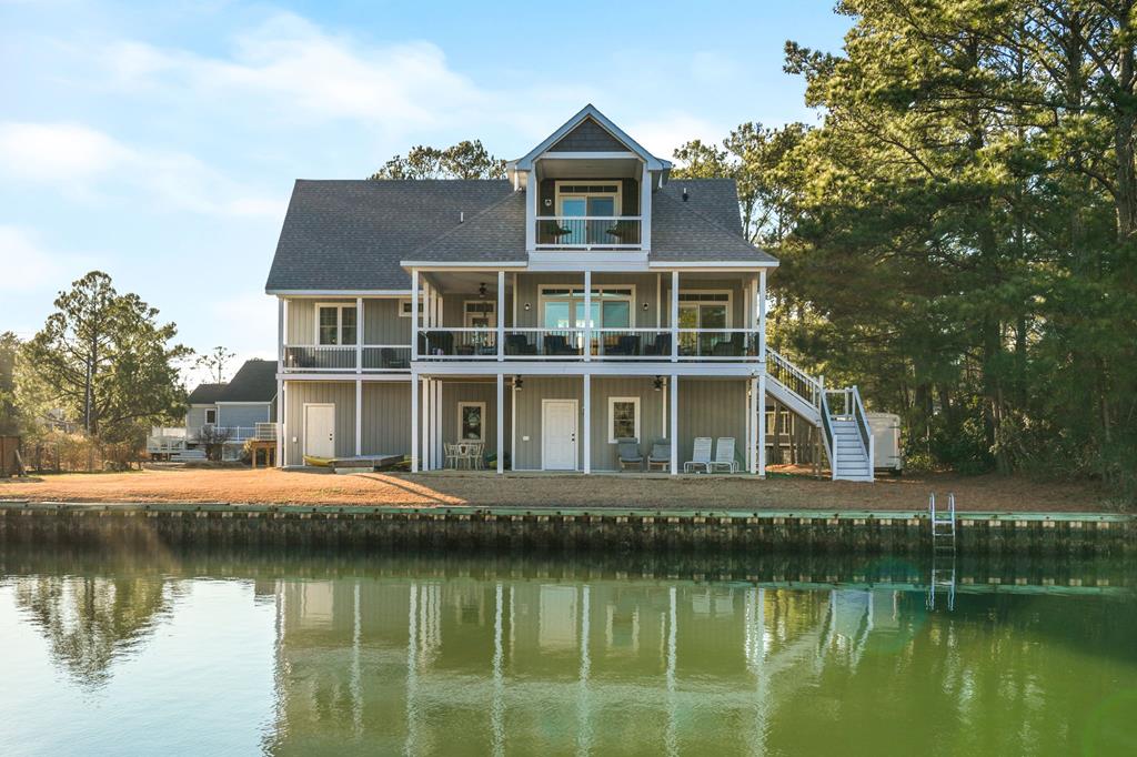 Enjoy canal-front living in Chincoteague's Oyster Bay community with beautiful views. Enter a bright foyer into an open floor plan with high ceilings and luxury vinyl plank flooring. The kitchen offers quartz counters, stainless appliances, induction cooktop & casual bar, flowing into sunlit living and dining areas that open to a large deck. Also on the main floor are two bedrooms, guest bath, laundry room, and office with deck access. Upstairs, a loft and fourth bedroom/media room complement the spacious primary suite with private balcony and luxurious spa bath. Below, an expansive unfinished basement offers storage. Outside, enjoy bulkheaded canal access—perfect for boating, kayaking, and fishing. Assateague's beaches and island attractions are just minutes away!