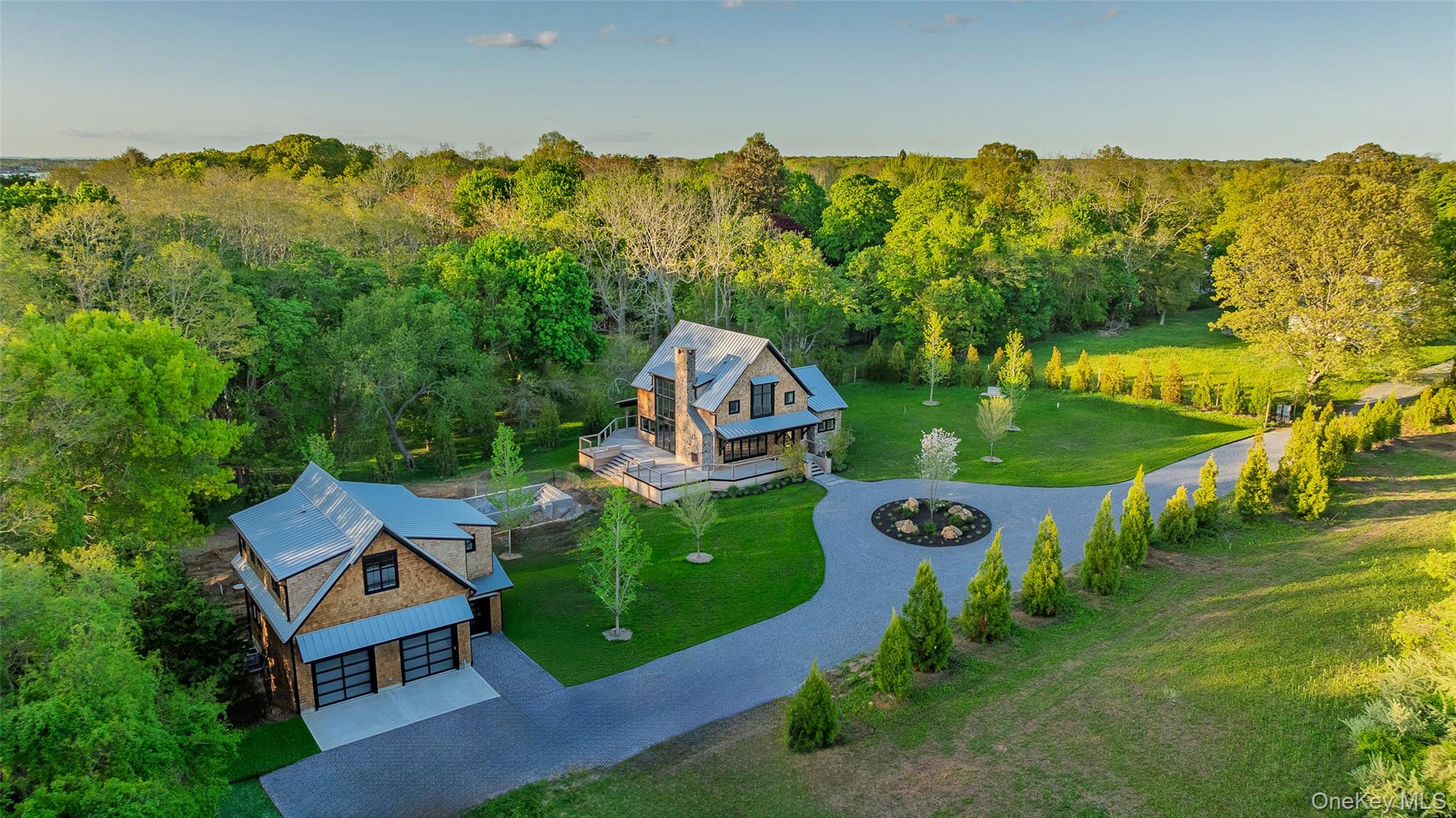 Welcome to this exceptional custom-built home nestled on 1.1 secluded acres, offering the perfect blend of luxury, comfort and privacy. Hidden at the end of a long driveway, the main house boasts 3 bedrooms and 3.5 bathrooms. The 1st floor main suite features include double doors that open to a private deck, a WIC and an expansive master bathroom equipped with a spa style rain shower. To add to the resort feel, the house is equipped with radiant flooring in all rooms and levels, a two story great room with an indoor/outdoor stone fireplace and a Chef's kitchen with custom-built cabinetry and granite counters. Large sliding doors lead you onto a wrap-around, mahogany deck with views of greenery and a stunning gunite pool. Upon leaving the main house, you will find every car lover's dream. A large barn style 4-car garage with ample height for additional car lifts. The 2nd floor features a 1 BR, 1 Bath apartment, full kitchen and an open floor plan living room/dining room.