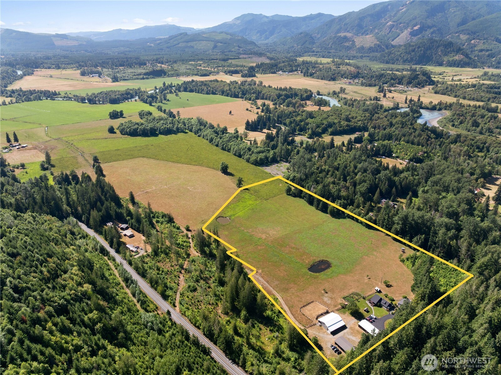 Set across 21 breathtaking acres at the heart of the greater Randle Legacy Farm, this extraordinary estate offers the perfect blend of luxury country living and proven income potential. The beautifully restored 1920 farmhouse features nearly 3,600 sq ft of timeless character with a chef's kitchen, expansive gathering spaces, and sweeping views of the valley, ponds, and surrounding mountains. A fully furnished attached apartment has been successfully operated as a thriving Airbnb, offering an established turnkey short-term rental opportunity. The detached ADU provides an excellent long-term rental or private space for multi-generational living. Step outside to enjoy a spacious custom deck, vibrant flower gardens, abundant raised garden beds, and beautifully landscaped grounds. Rolling pastures are currently leased to a local cattle rancher, generating passive income, or can be used for your own livestock, horses, or hay production. The impressive heated four-bay garage/shop is ideal for projects, equipment, hobbies, or a home-based business. A substantial barn and massive equipment shed provide exceptional agricultural versatility. This remarkable property is more than a home—it's a rare opportunity to own a legacy estate with multiple established income streams and unlimited lifestyle potential. Ask your broker about the custom website and additional properties available.