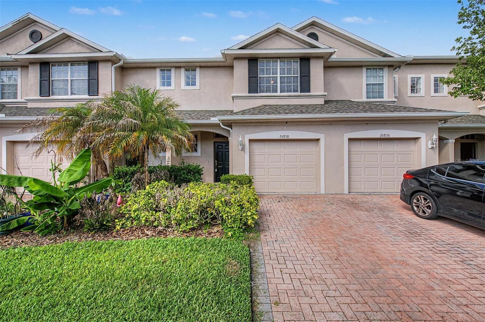 One or more photo(s) has been virtually staged. POND-VIEW TOWNHOME IN SEVEN OAKS | 3 BEDROOMS + LOFT | RESORT-STYLE AMENITIES | Wake up to peaceful pond views and enjoy resort-style living in one of Wesley Chapel's most sought-after communities.  This spacious 3-bedroom, 2.5-bath townhome with a 1-car garage offers over 1,700 square feet of comfortable living space, an upstairs loft, and a private setting with no rear neighbors while situated in a gated community.  Step inside to find an open-concept floor plan designed for both everyday living and entertaining.  The spacious living and dining areas flow seamlessly into the kitchen, which features abundant cabinetry, generous counter space, a breakfast bar, pantry, and plenty of room for gathering with family and friends.  Large windows across the rear of the home bring in natural light while showcasing tranquil pond and conservation views.  Upstairs, a versatile loft provides the perfect space for a home office, media room, playroom, or additional living area.  The primary suite offers dual walk-in closets and an ensuite bath with dual vanities and a walk-in shower.  Two additional bedrooms are generously sized and share a full bathroom, while the upstairs laundry room adds convenience to everyday living.  Relax on the covered rear patio overlooking the water, where you'll enjoy a peaceful backdrop rarely found in townhome living.  *ROOF (2025) & A/C (2021)*  Located within the highly desirable Seven Oaks community, residents enjoy access to an impressive amenity center featuring resort-style pools, a waterslide, splash area, clubhouse, fitness center, tennis courts, basketball courts, playgrounds, parks, walking trails, and year-round community events.  Conveniently located near shopping, dining, top-rated schools, medical facilities, Wiregrass Mall, Tampa Premium Outlets, and I-75, this home offers the perfect combination of comfort, convenience, and lifestyle.  Whether you're a first-time buyer, relocating to the area, downsizing, or searching for a low-maintenance investment opportunity, this home delivers exceptional value in one of Wesley Chapel's premier communities.