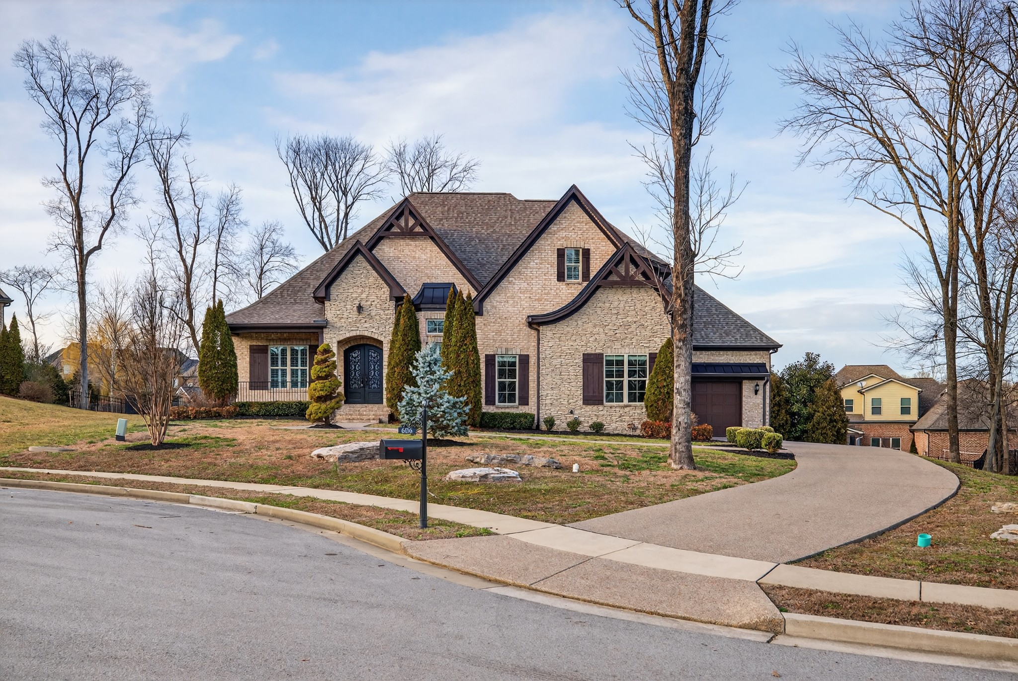 If you’ve been waiting for a true custom home in one of Nolensville’s premier luxury neighborhoods, this one is worth your immediate attention. Located in sought-after Benington—known for its manicured streetscape, half-acre estate lots, sidewalks, trail connectivity, shared pool/playground amenities, and close proximity to the Sunset school campus and Williamson County Rec Complex—this home delivers the space, craftsmanship, and setting luxury buyers want.Built by Tennessee Valley Homes, a Nashville-area custom builder known for exquisite floor plans and upscale finishes, this home has just been refreshed to show like new with all new interior paint, refinished hardwoods, updated lighting, and recent maintenance. Major peace-of-mind updates include a 2023 roof replacement and a 2025 large HVAC unit.The main level is designed for both everyday comfort and impressive entertaining with iron double front doors, two bedrooms on the main level, a private study with French doors, formal dining with coffered ceiling, and a well-appointed kitchen featuring a large island, double ovens, built-in gas range, and breakfast nook. The Great Room stuns with a soaring coffered ceiling, built-in speakers, stacked stone fireplace to the ceiling, and built-in bookcases. Plantation shutters add a polished finish throughout.The primary suite opens directly to the screened porch and offers a luxe bath with split vanities, garden tub, separate shower, and dual custom closets. Upstairs, enjoy a large bonus room with wet bar plus two additional bedrooms with full baths. Out back, the screened porch with stamped concrete, fireplace, and TV-ready setup flows to a patio with natural gas hookup. Side-entry 3-car garage with oversized carriage bay. Just minutes away, Nolensville’s new Publix center is complete, while the future Kroger-anchored Darcy development remains in the pipeline. Move quickly.