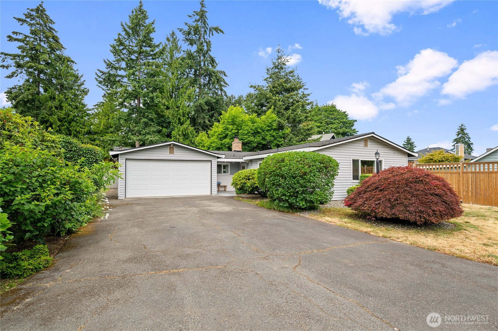 Wonderful single-level living in Burien's highly sought-after Gregory Heights neighborhood, just two blocks from the peaceful shores of Lake Burien. Tucked away on a quiet cul-de-sac, this well-maintained home offers 3 bedrooms and 2 full bathrooms, including a spacious primary suite with a walk-in closet and private bath. Designed for comfortable everyday living and effortless entertaining, the home features formal Living and Dining rooms, plus a large Family Room that opens to an expansive covered patio and fully fenced backyard—perfect for year-round gatherings. Fresh interior paint, new carpeting, and beautifully preserved original hardwood floors blend timeless mid-century character with an updated feel. An attached garage and oversized driveway provide ample parking and storage. Enjoy convenient access to Hwy 509, Downtown Seattle, and Seattle–Tacoma International Airport, while being just minutes from the charming shops, restaurants, and community events of Olde Burien. This is a rare opportunity to enjoy a quiet neighborhood setting with exceptional convenience and Northwest charm.