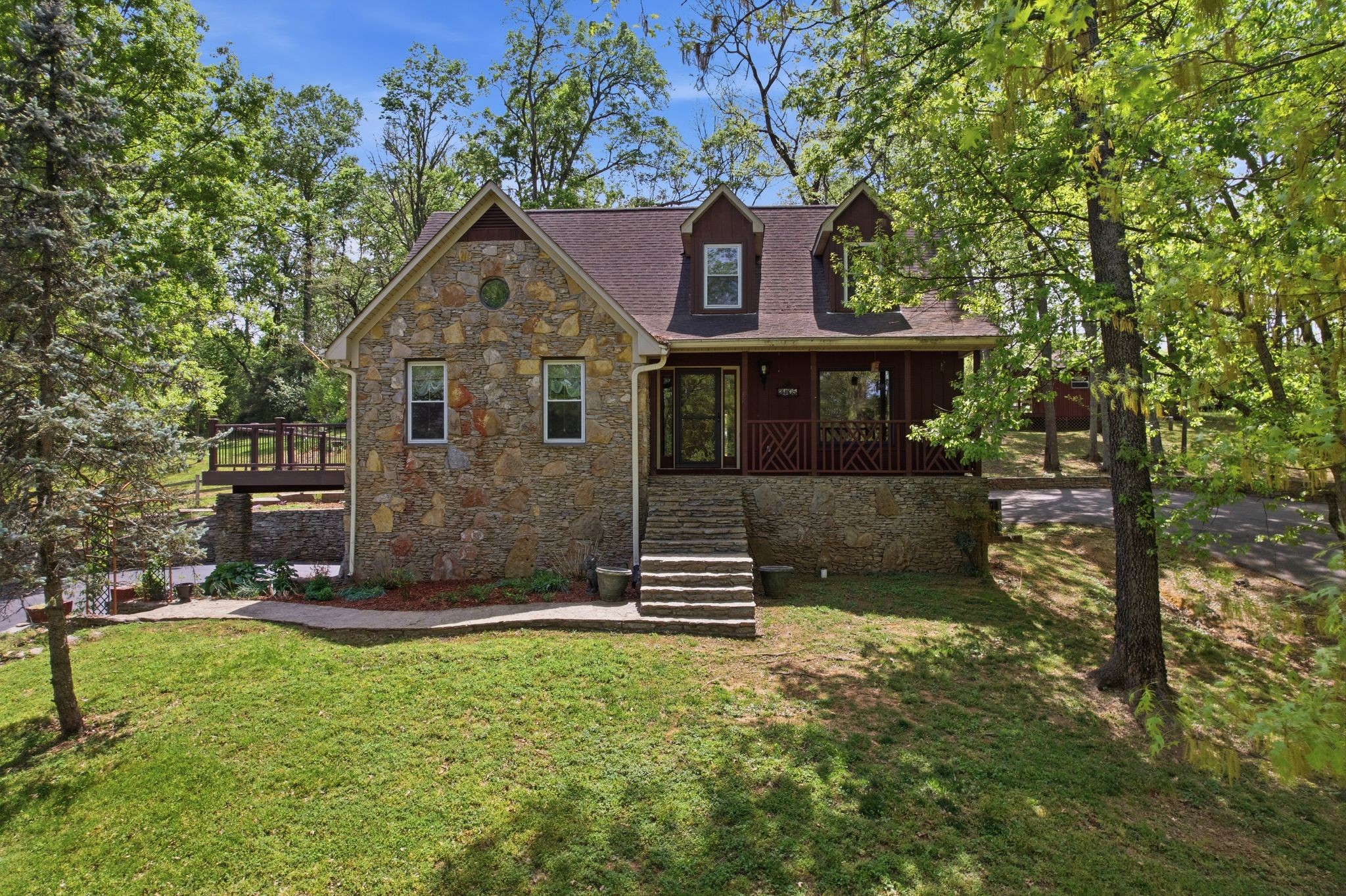 Country charm with city convenience! Charming rustic retreat featuring natural stone exterior paired with western cedar accents. Nestled among mature trees on an expansive 1.72 acre lot, the home has a timeless, lodge-inspired feel that blends seamlessly with its wooded setting. Offering 3 bedrooms 3 1/2 baths, basement mother-in-law or teen suite with new flooring, Amish hand-cut oak flooring, remodeled kitchen and bathrooms, new HVAC units, new windows. Outside you'll find  a 20x25 shop, puttering/garden shed, 3 driveways, fenced backyard, 3 water features, trex decking, hand picked stone walkways. Located only 1/2 mile from Maury Regional Hospital, shopping and dining !