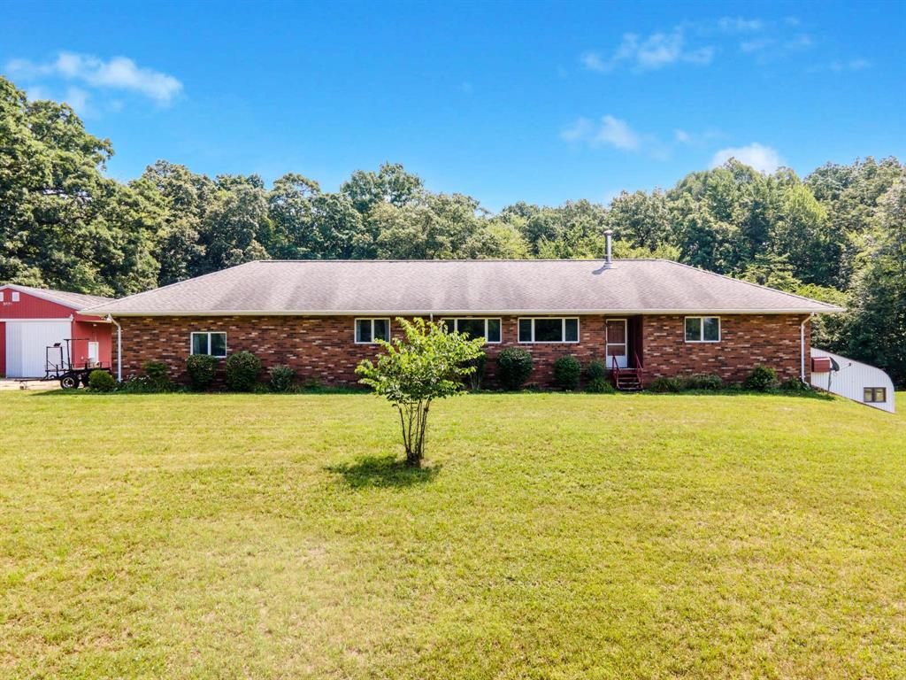 You'll have immediate occupancy when you purchase this large brick ranch situated on 10 acres with a pole barn.  This home has a split floor plan with two bedrooms on one end and the primary separated from the other bedrooms. Two of the bedrooms have walk-in closets and the laundry is on the first floor as you enter from the 2.5 car garage. There is a finished basement with an attached greenhouse, perfect for growing your food year round.  This home sits far off the road and is private and full of wildlife for you to enjoy.  The pole barn has concrete floor, electric and includes 220 for welding. This property is perfect for a gardener, hunter or someone who wants to be away from it all. Add fresh paint and new flooring and the house will be like new!