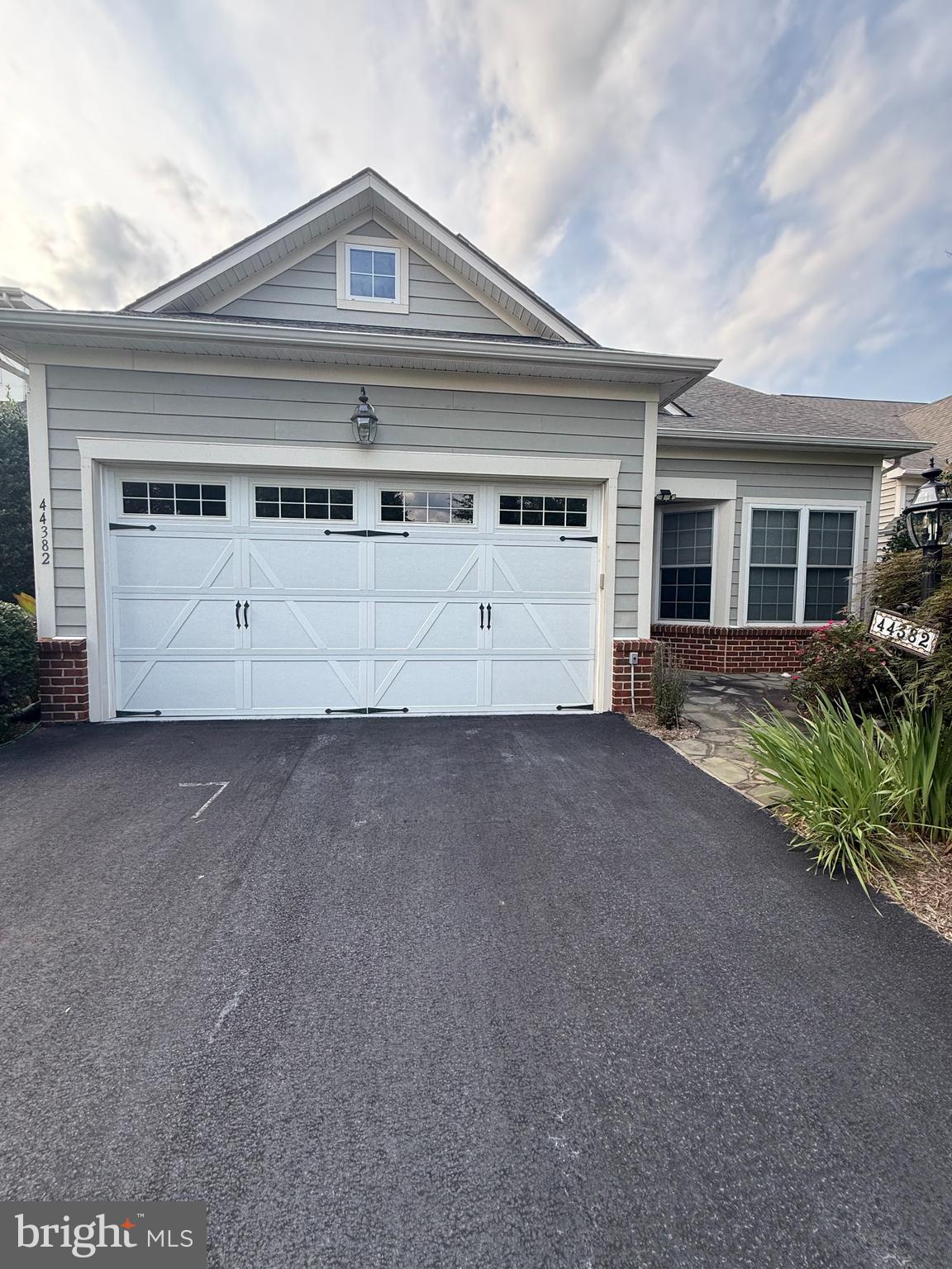 Beautiful home in the sought-after 55+ active adult community of Potomac Green! This popular Powell model offers 3 bedrooms and 3 full bathrooms with a thoughtfully designed layout ideal for comfortable everyday living and entertaining.The gourmet kitchen features 42-inch cabinetry, granite countertops, double ovens, and KitchenAid stainless steel appliances, opening to inviting living and dining spaces. The spacious dining room provides plenty of room for holiday dinners and memorable gatherings with family and friends.The main-level primary suite offers exceptional convenience and features a spacious en-suite bathroom with both a separate standing shower and soaking tub. A second bedroom is also located on the main level, with easy access to a full hallway bathroom, making it perfect for guests, a home office, or flexible living space.Upstairs, the private loft provides additional living space along with a third bedroom and full bathroom—an ideal private retreat for visiting family and overnight guests.Step outside and enjoy the peaceful tree-lined, shaded patio, perfect for relaxing or entertaining. The gas grill conveys, making the outdoor space ready for year-round barbecues and gatherings.Potomac Green offers an exceptional resort-style lifestyle with a clubhouse, swimming pool, fitness and recreation amenities, walking trails, dog parks, and more. Ideally located near One Loudoun's premier shopping, dining and entertainment, INOVA Loudoun Hospital, major commuter routes, and Dulles International Airport.Move-in-ready home offers the perfect combination of comfort, convenience. Come experience everything Potomac Green has to offer and make this wonderful home yours!