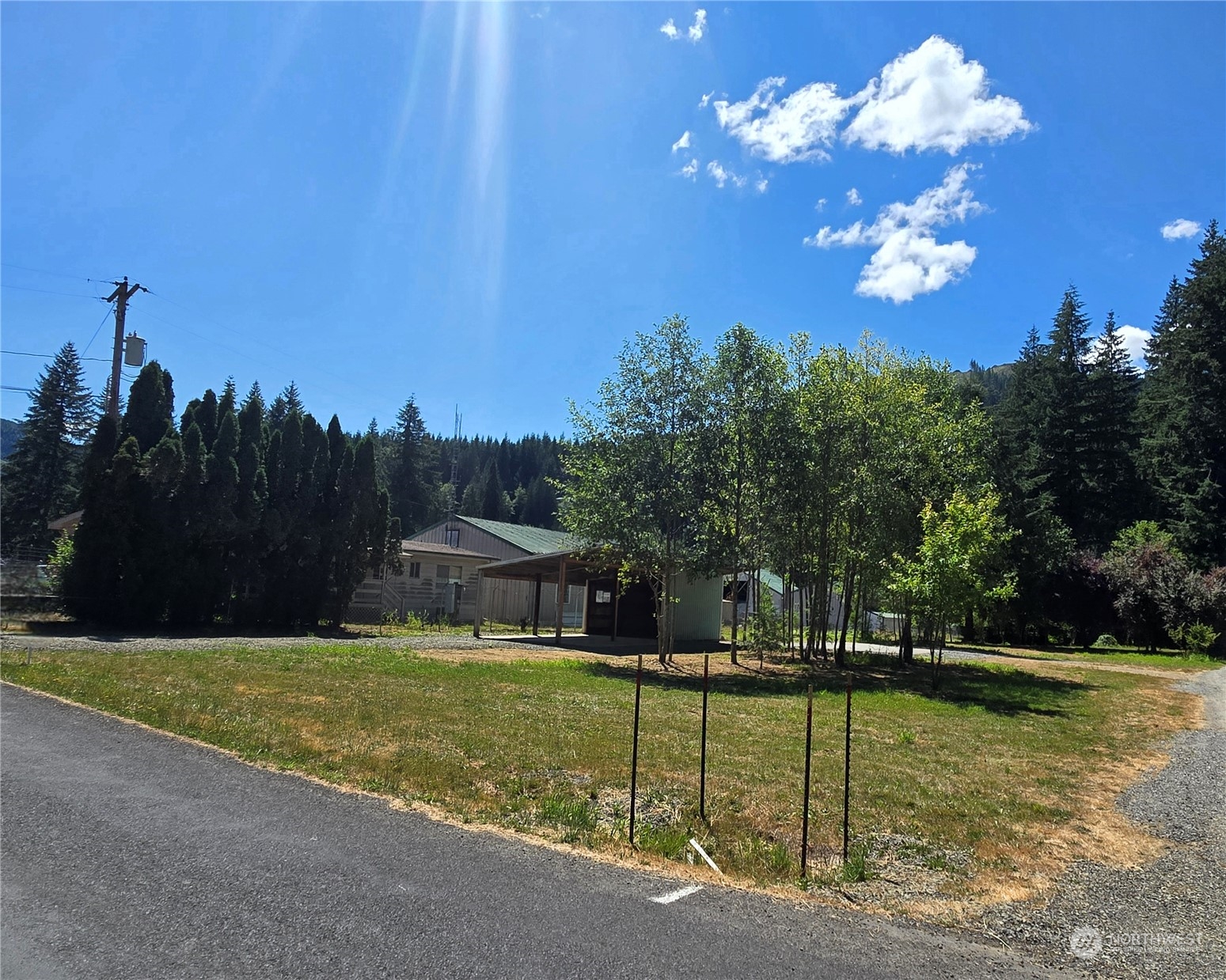 Nice level parcel ready for your home. This 1 acre parcel is landscaped and has some large trees at the back of the property! 68' individual well on the propety. 24'x40' concrete slab and a 20'x28' double carport with concrete slab and an attached utility room with gravel floor.