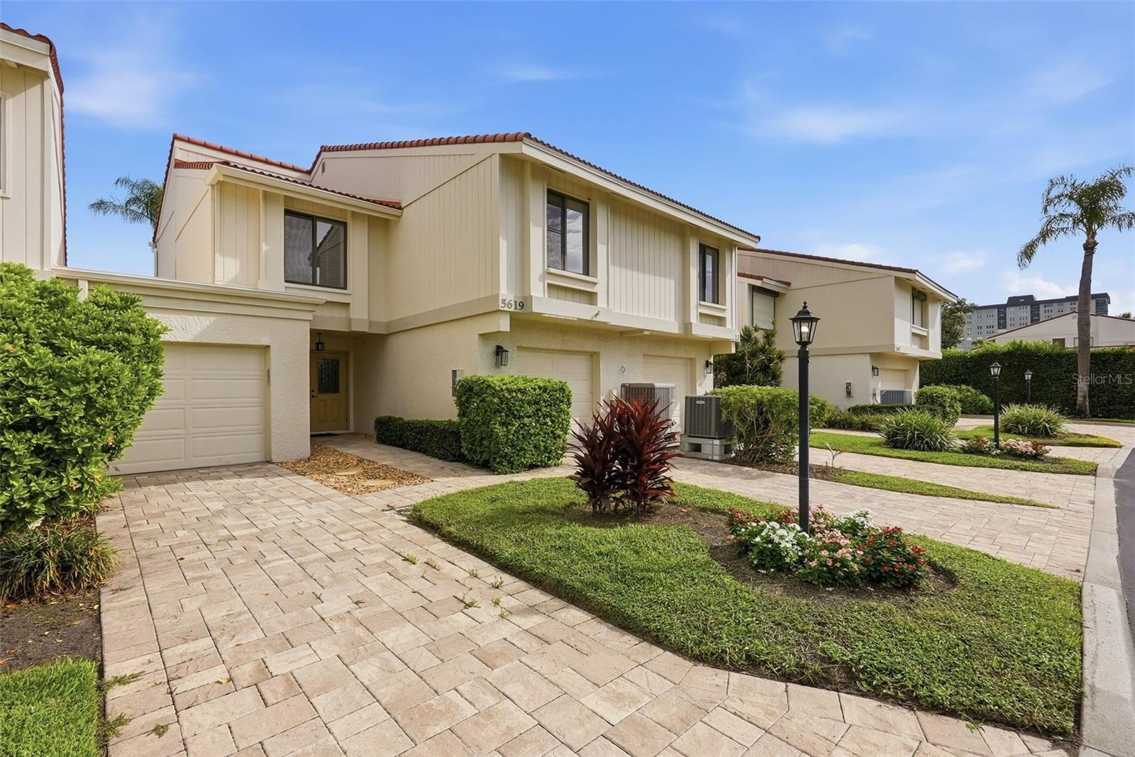 Experience island living at its finest in this beautifully appointed luxury townhome in the desirable Playa Escondida community on fabulous Isla Del Sol. This spacious open-concept residence features 3 bedrooms, 2.5 baths, a versatile bonus room, and a 2-car garage. Enjoy breathtaking, wide-open golf course and island views from the expansive lower-level deck or retreat to the private balcony off the primary suite. The inviting kitchen offers Corian countertops, abundant custom cabinetry, a built-in desk, quality appliances, upgraded fixtures, and recessed lighting, making it both stylish and functional. The main living area showcases soaring volume ceilings, while the spacious primary bedroom features vaulted ceilings, sliding glass doors leading to the private balcony, and a large walk-in closet with custom storage-system built-ins. All bathrooms are thoughtfully finished with tasteful, timeless selections. Playa Escondida is an intimate 43-home waterfront community along Boca Ciega Bay, offering residents an exceptional array of amenities including a community swimming pool, tennis courts, fishing pier, and private beach area. Ideally located just minutes from the Gulf beaches, Fort De Soto Park, shopping, dining, and Interstate 275, this exceptional Isla Del Sol townhome offers the perfect blend of luxury, privacy, resort-style amenities, and coastal convenience.
