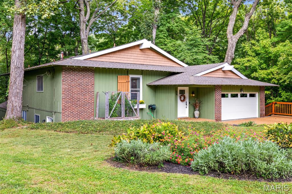 Tucked away on a quiet cul-de-sac in the desirable, tree-lined River Bend Estates neighborhood in Chesterfield, 56 River Bend offers privacy, character and wonderful views of nature. Set on 1.6 acres, this charming and surprisingly spacious split-level 4-bedroom, 2.5-bath home was built by noted St. Louis-area builder and developer Burton Duenke, well known for his Chesterfield neighborhoods and as the developer of the original Tan-Tar-A Resort at the Lake of the Ozarks. Abundant windows and natural light create a warm, inviting atmosphere throughout. A remarkable addition is the standout space, with wood-beamed ceilings and windows on three sides that make it feel like a treehouse tucked into the woods. It’s the perfect spot to watch the seasons change and enjoy the frequent wildlife. Outside, a brick patio offers a private setting for relaxing or entertaining, while the fireplace is ideal for gathering on crisp fall evenings. A basement / workshop area with abundant storage space sits underneath the garage with its entrance off the deck. With its wooded setting, unique spaces and 1.6-acre lot, 56 River Bend is a special home that you won’t find anywhere else.